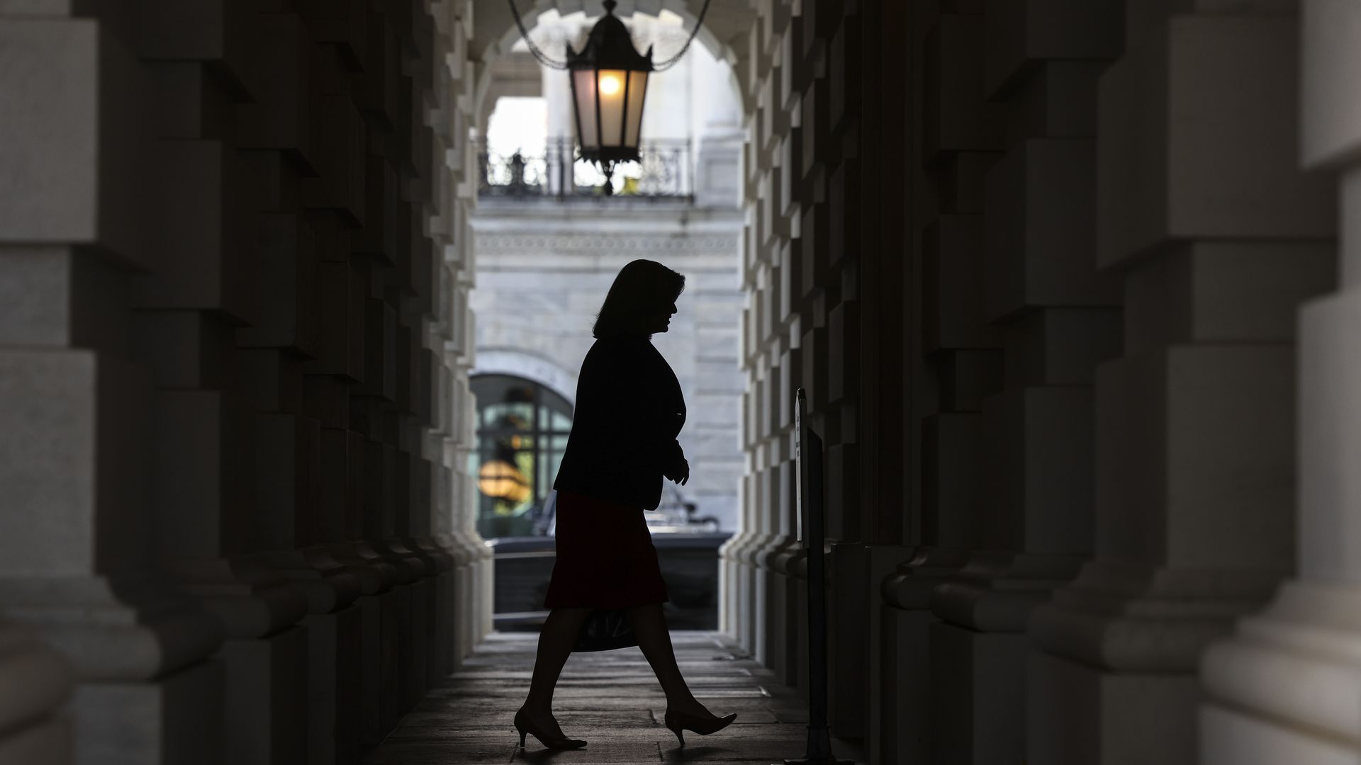 Sen. Joni Ernst is seen in silhouette arriving at the U.S. Capitol.