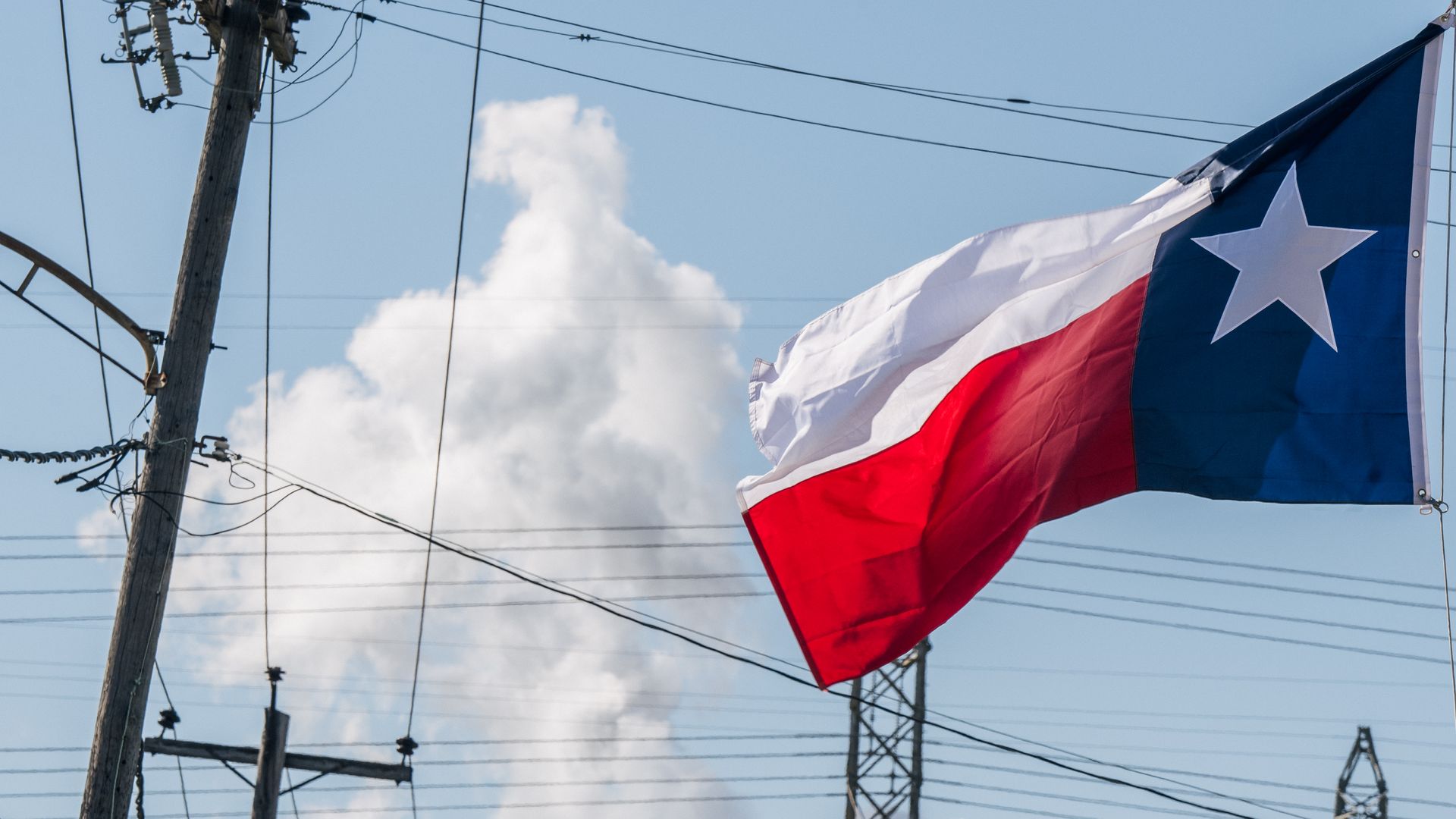 Photo of a Texas state flag flying in the air
