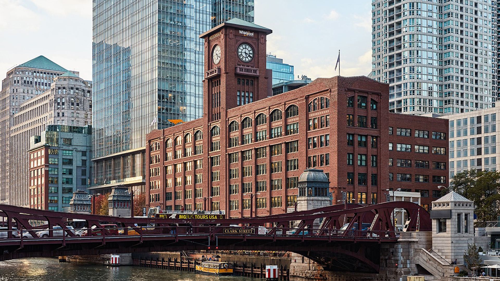 Photo of a building along a river and next to a bridge 