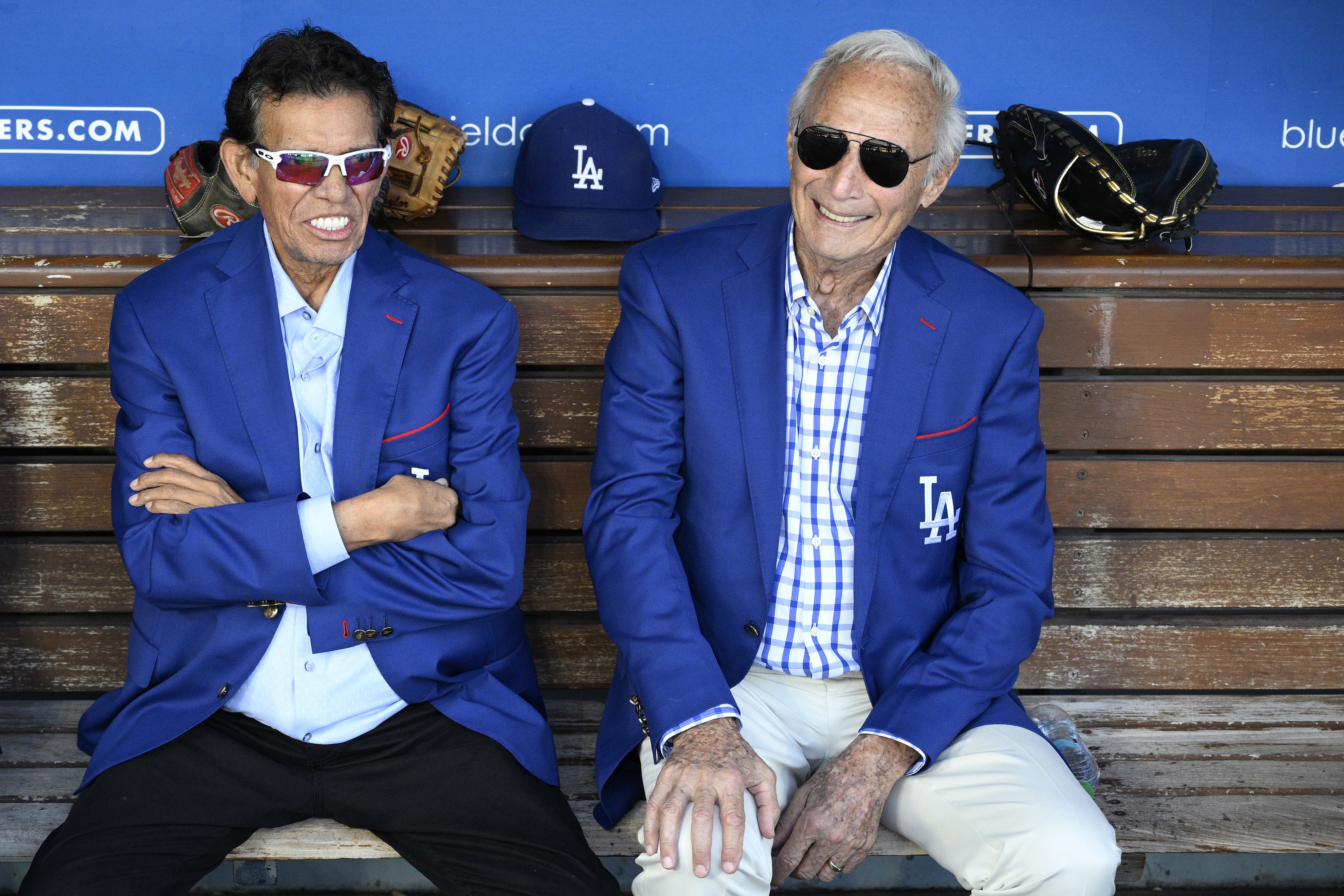 Fernando Valenzuela sits with his arms crossed next to Sandy Koufax