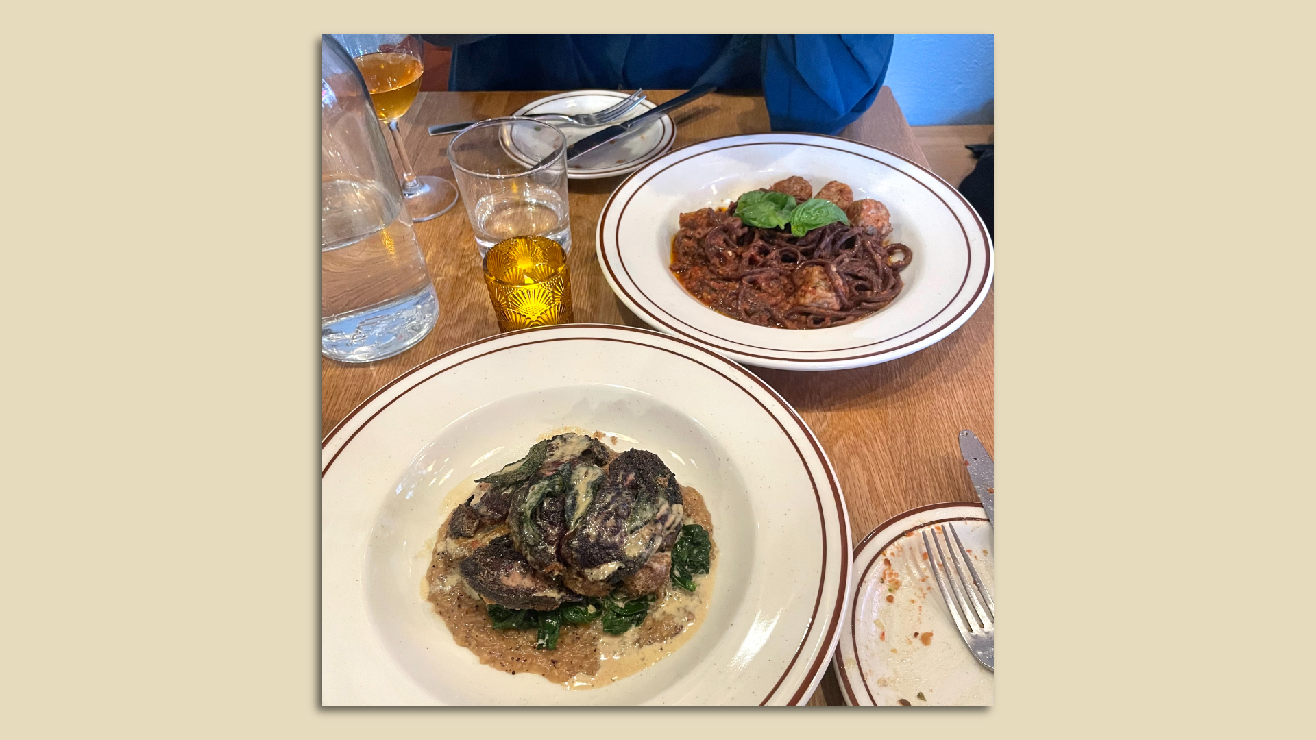 A photo of two plates on a wood grain table.