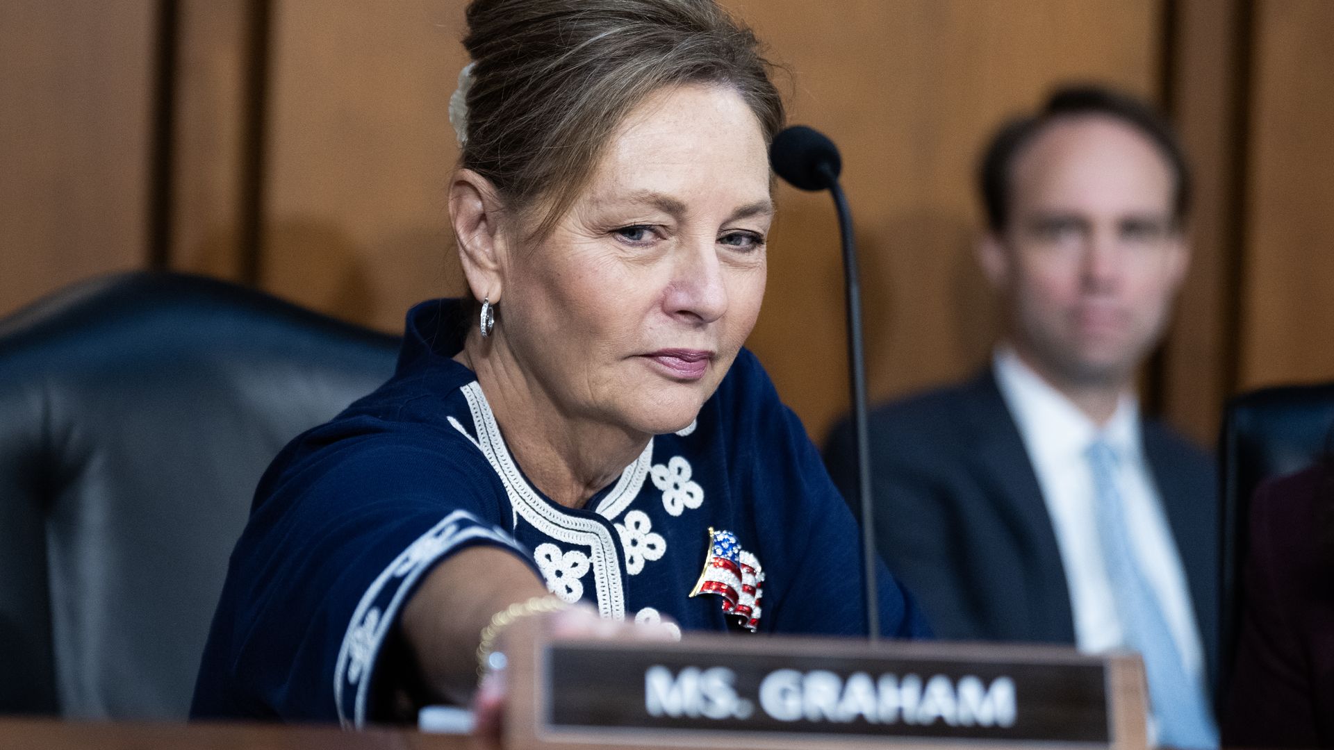 Sen. Darline Graham (R-S.C.) adjusts her new nameplate during a hearing on Capitol Hill.