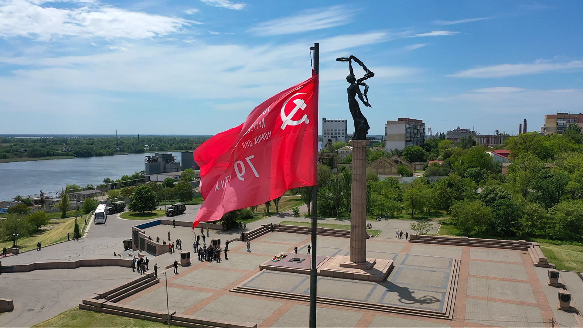 Soviet Banner of Victory flying near a WWII memorial in the Russian-occupied city of Kherson on in May 2022..
