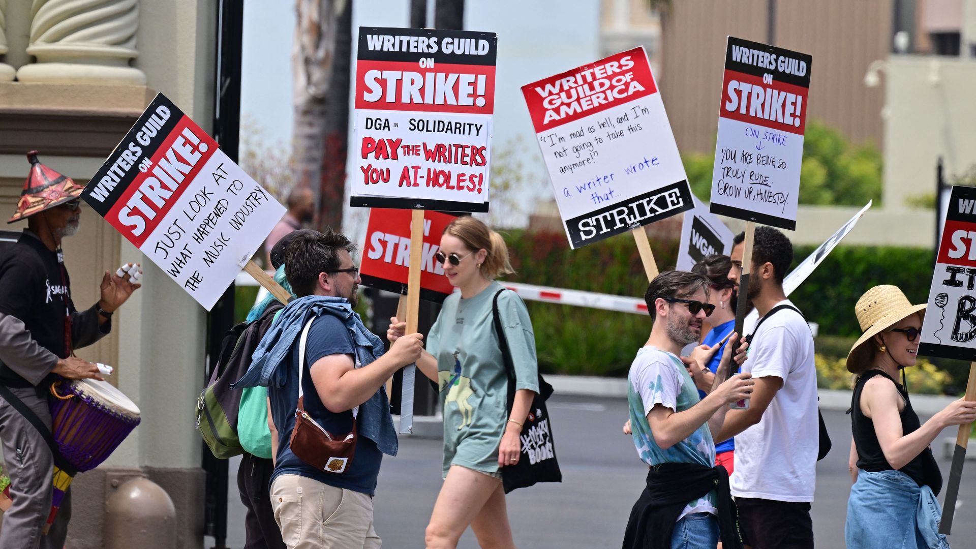 Writers hold signs while picketing in front of Paramount Studios in Los Angeles, California on May 15, 2023.