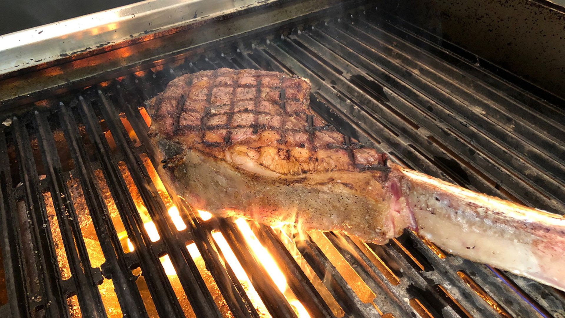 steak on grill at new york butcher shoppe