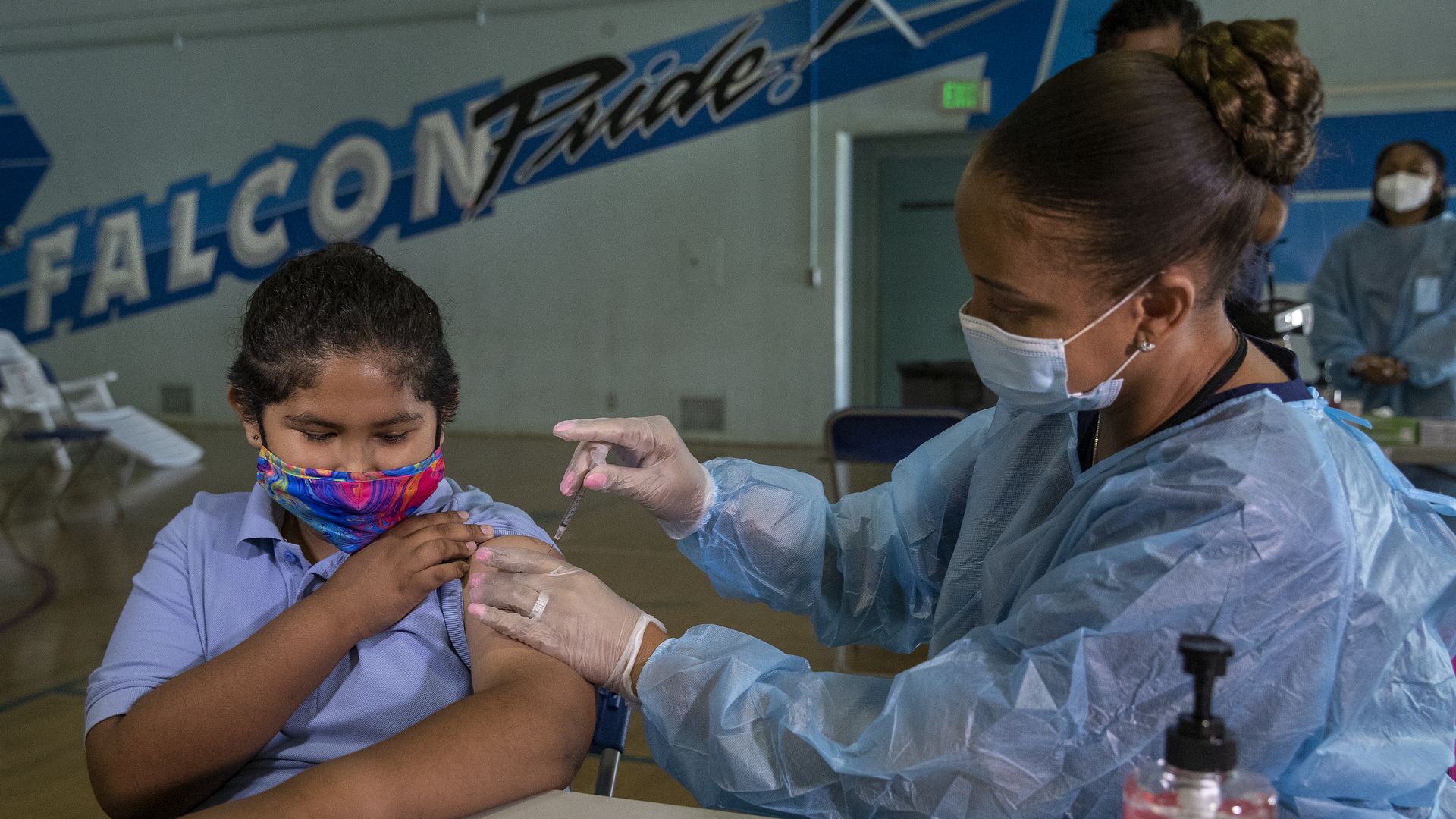 A 12 year old receives the first dose of the Pfiizer vaccine from a licensed vocational nurse.
