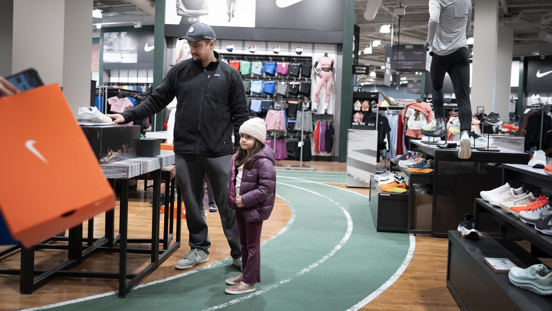 People shopping in a Dick's Sporting Goods store.