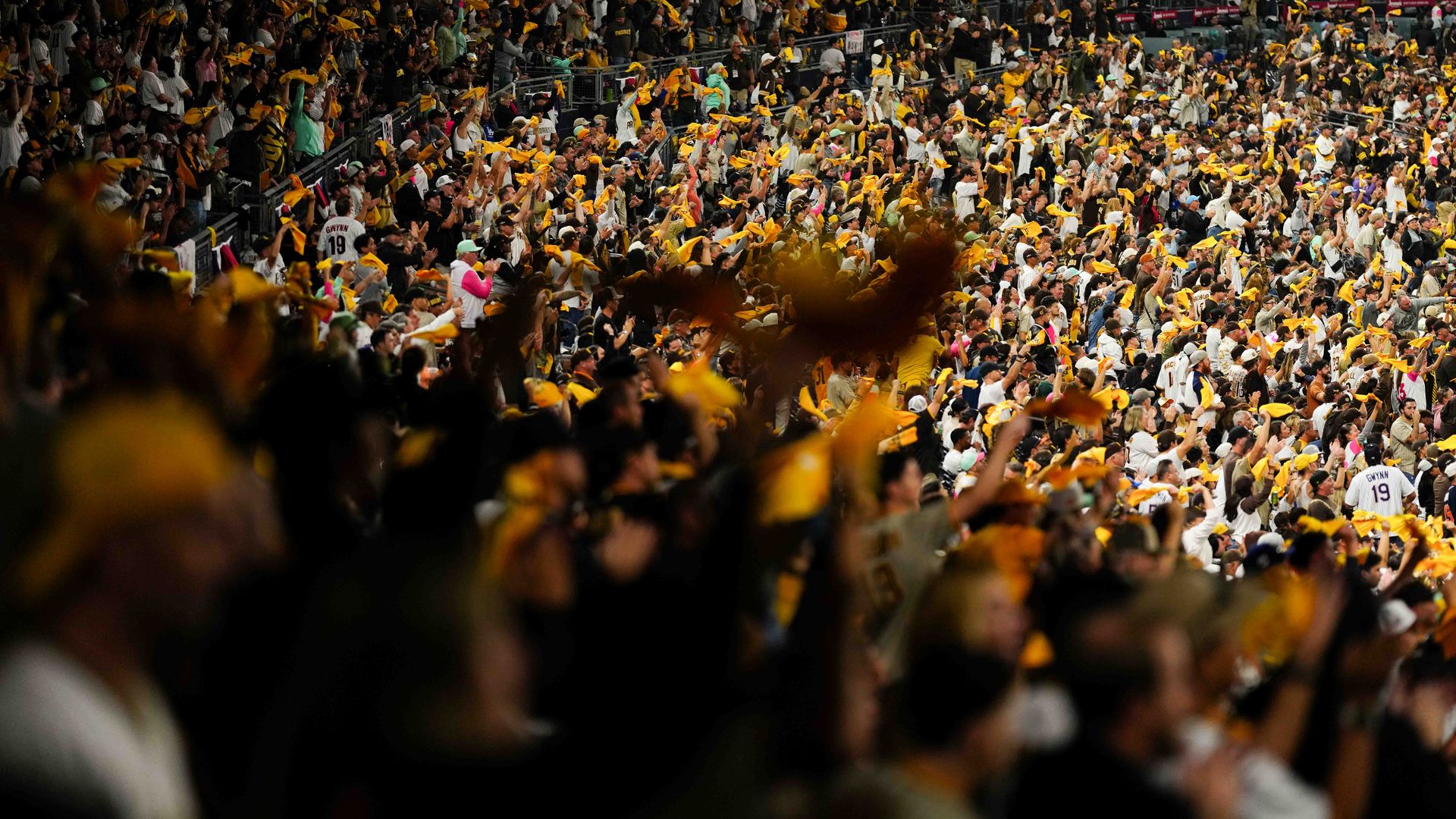 Crowd shot of Padres fans in Petco Park waiving yellow towels
