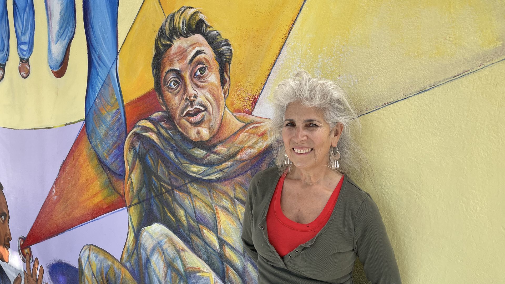 Juana Alicia in front of her mural.