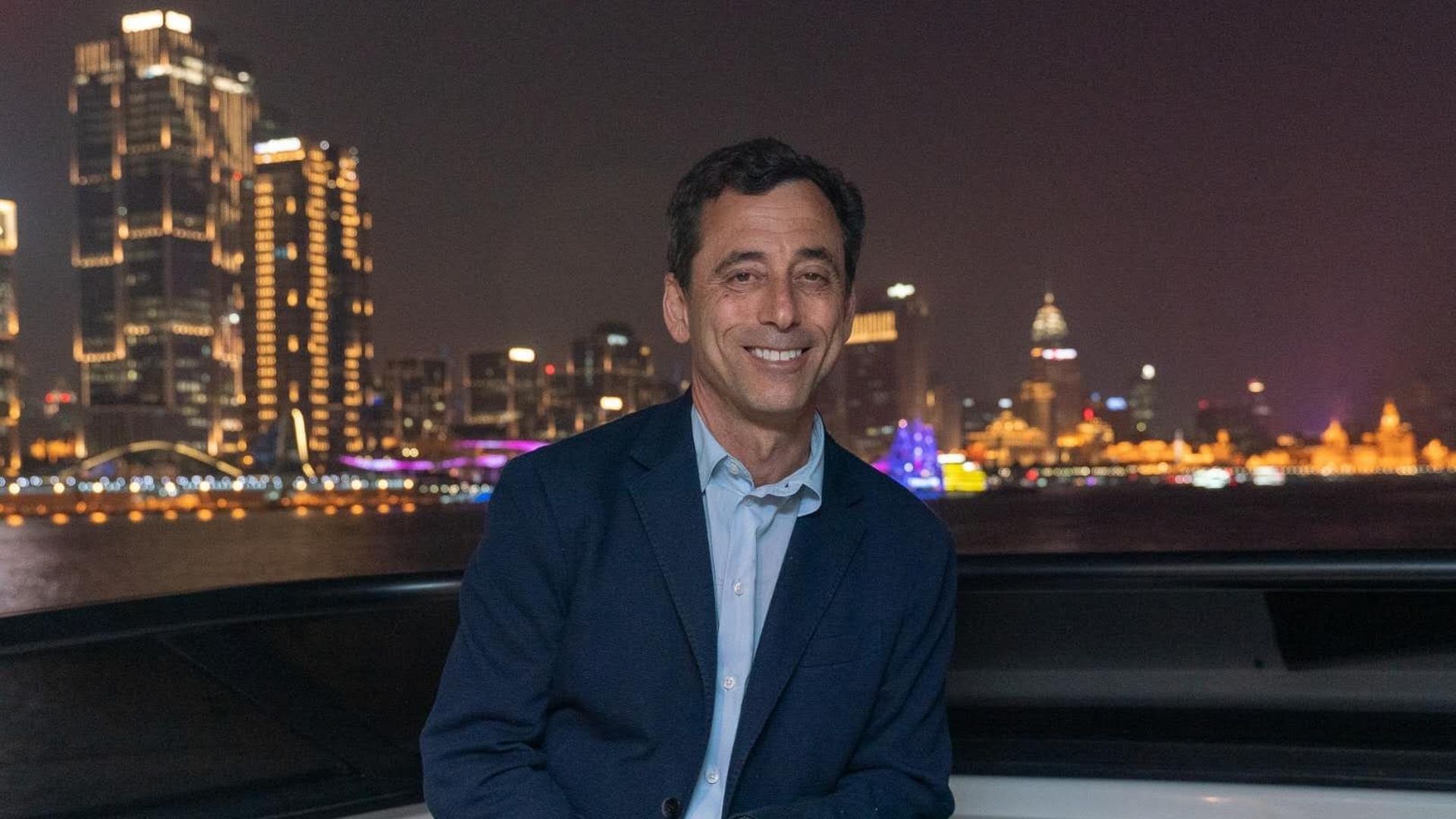 Guy in front of a night skyline