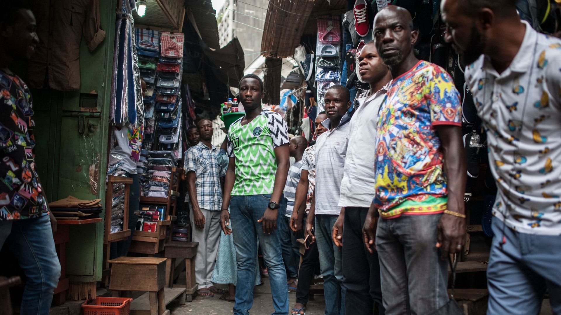 A group of Nigerian young men standing in a market 