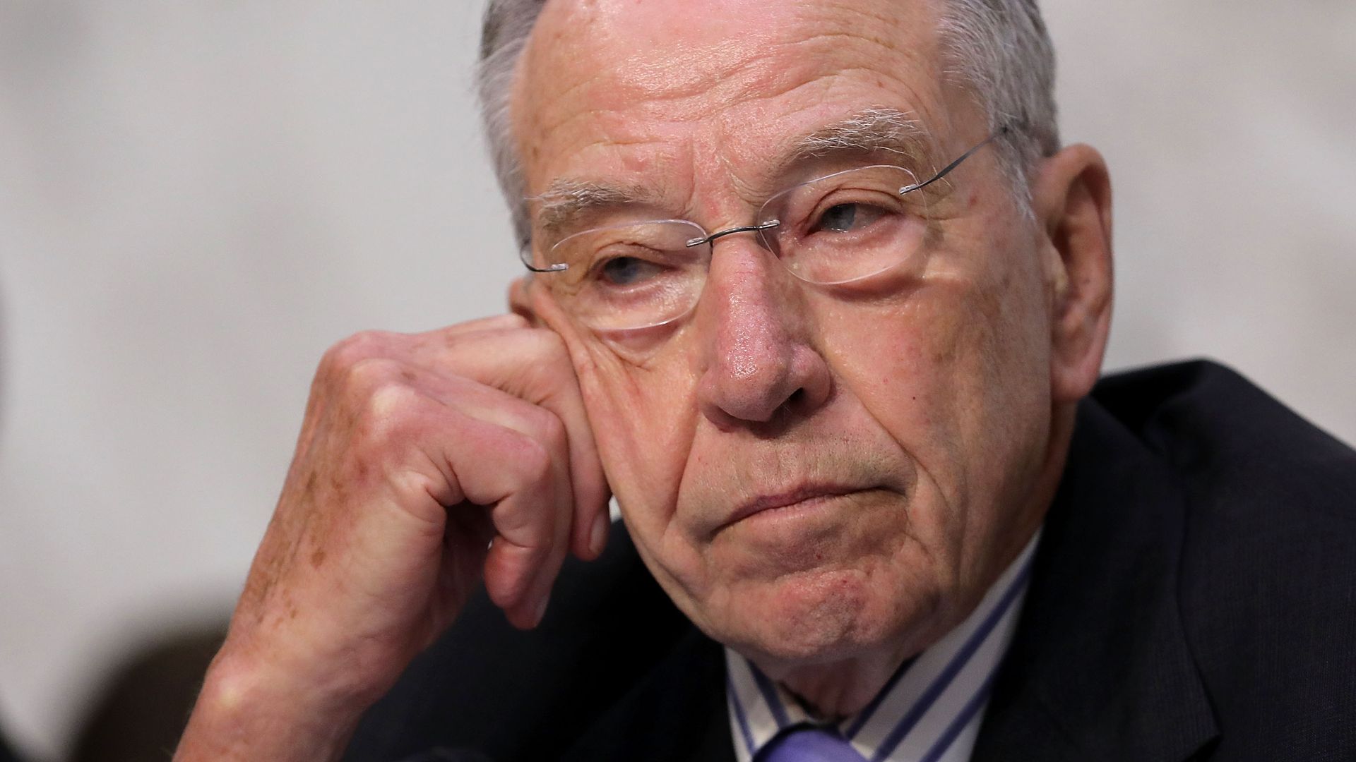Chuck Grassley rests his head on his hand while in thought