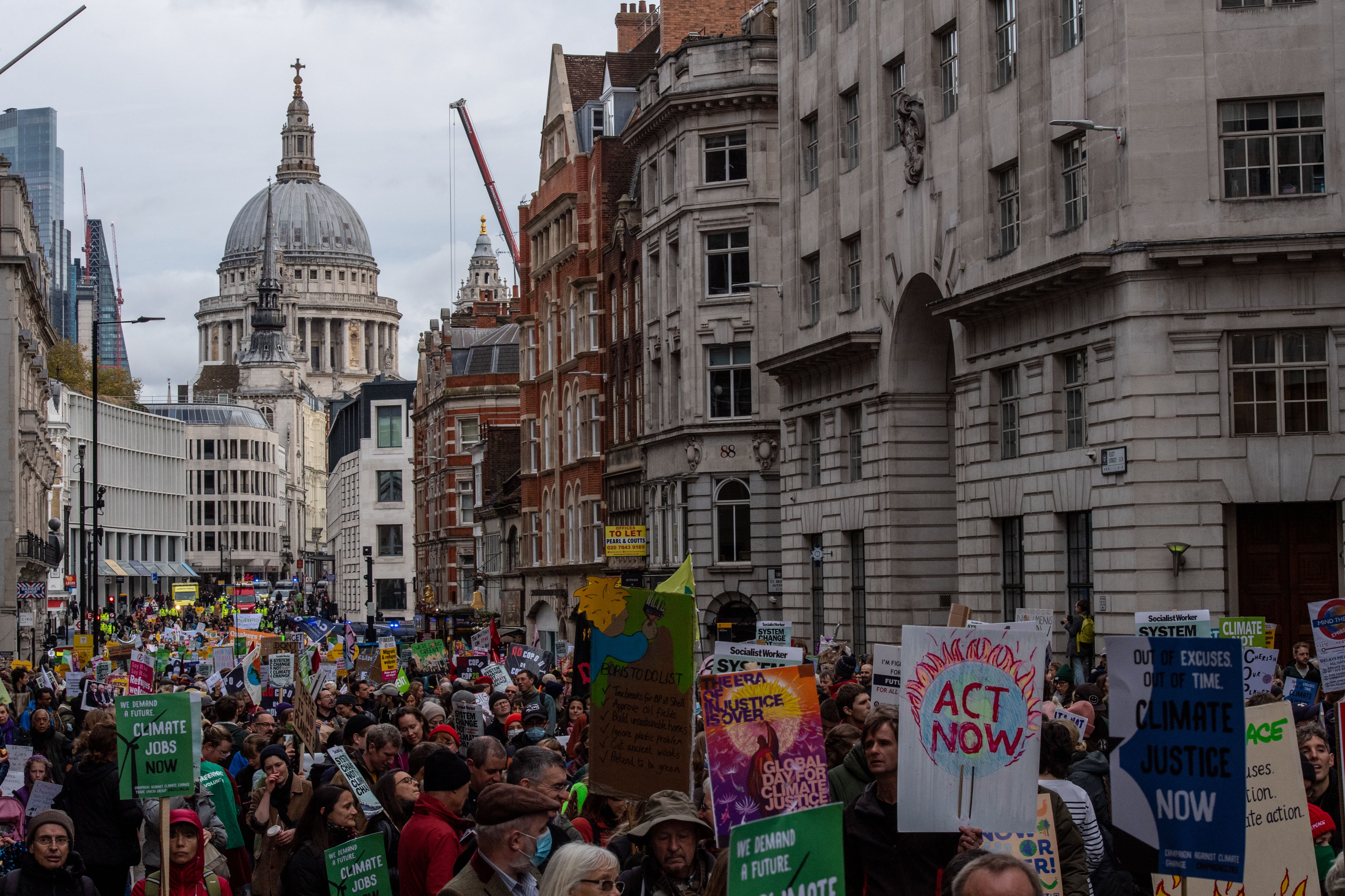 Protesters march along Fleet Street during a global day of action on climate change on November 6, 2021 in London, United Kingdom.