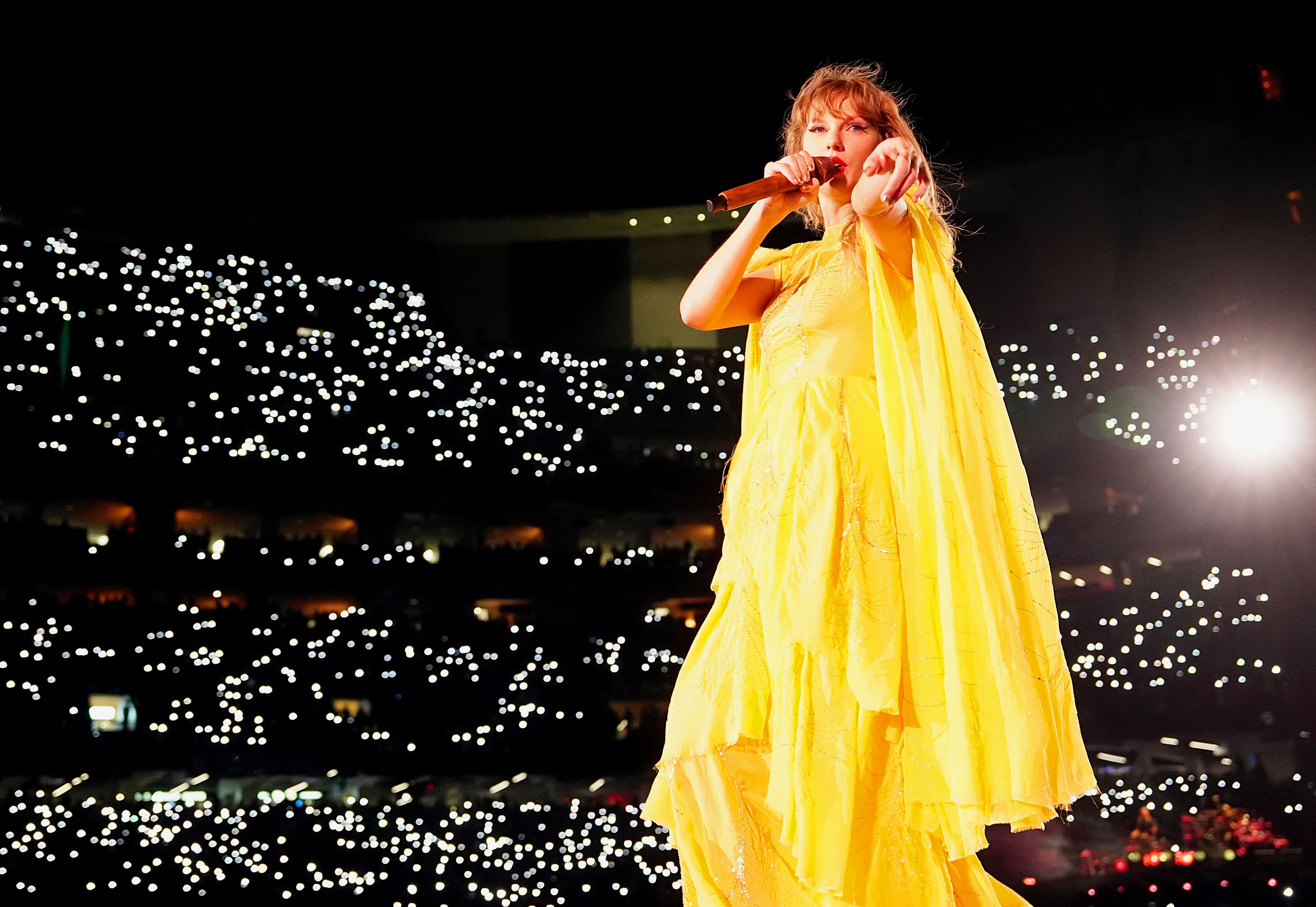 Photo shows Taylor Swift in a yellow dress.