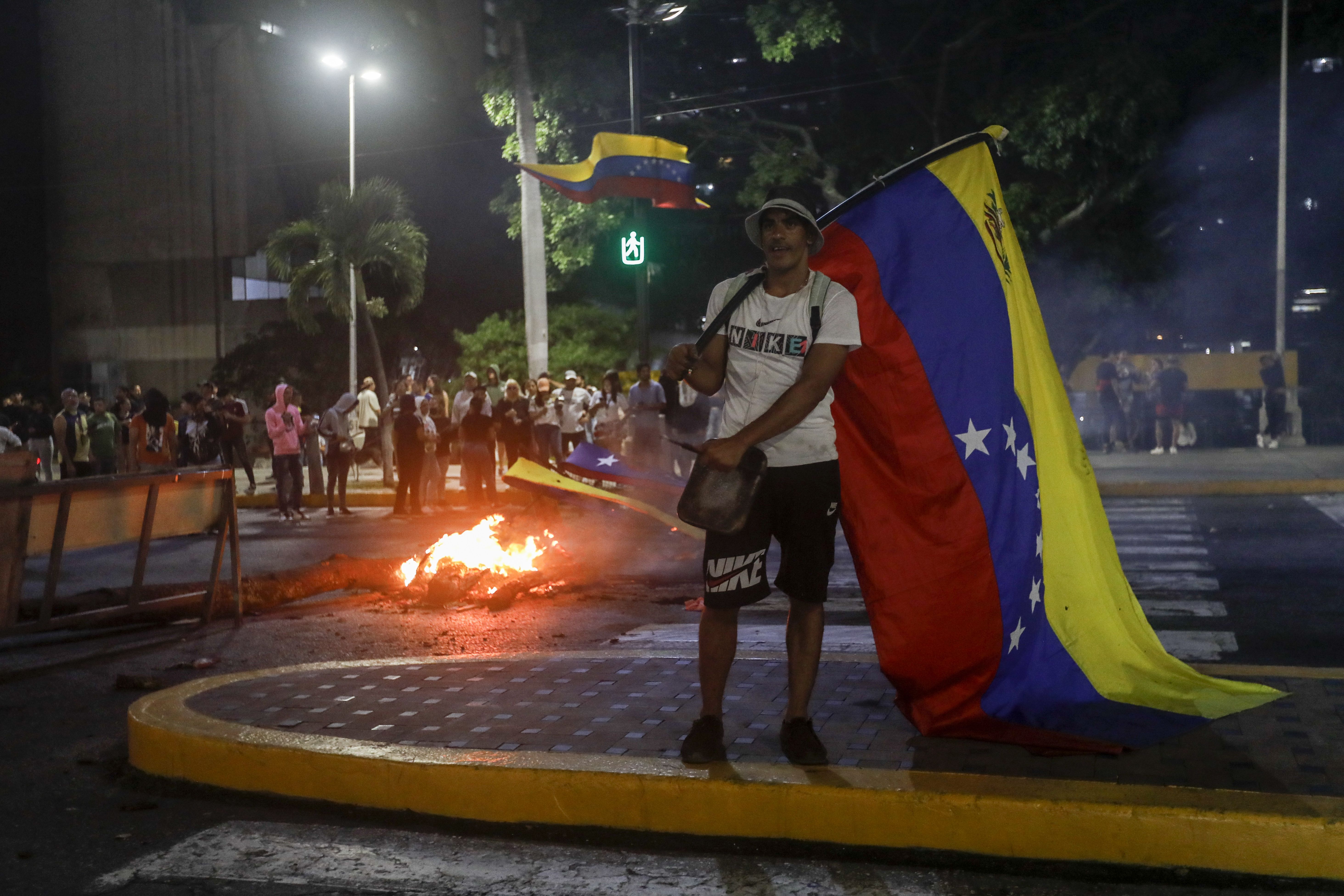  Demonstrators burn rubber and objects during a protest against reelection of Venezuelan President Nicolas Maduro for the 3rd term one day after the Venezuelan presidential elections in Caracas, Venezuela on July 29, 2024.