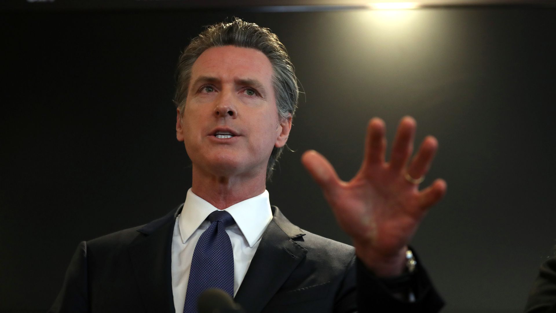 California Governor Gavin Newsom speaking with his hand out