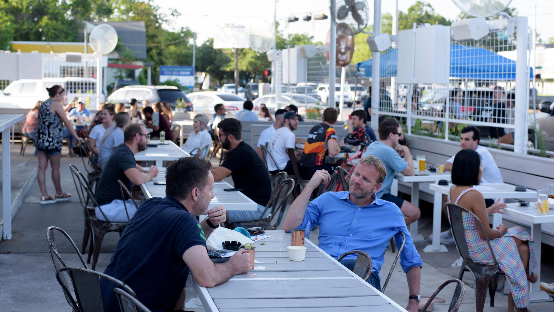 Customers sit outside a bar