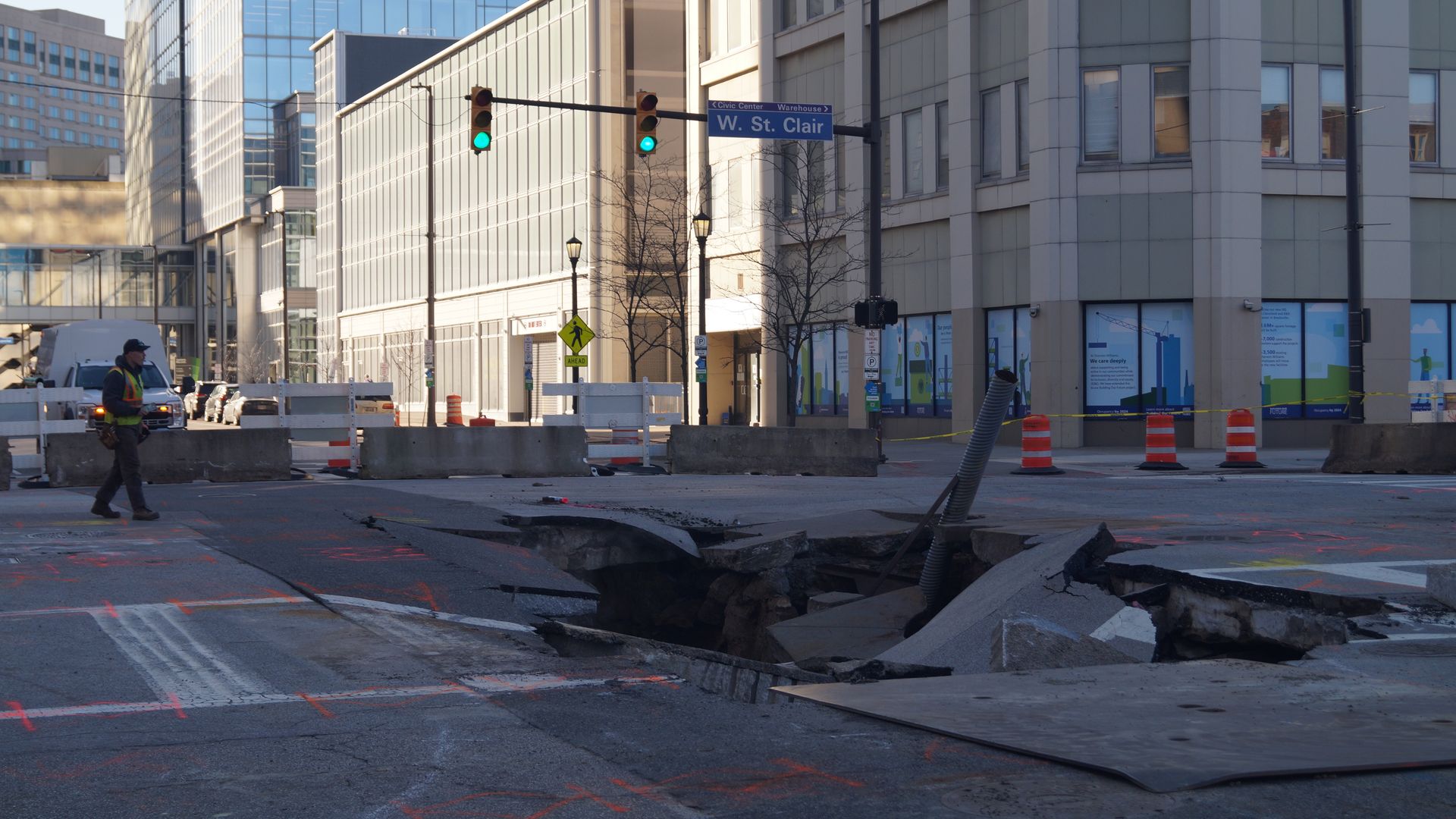 Sinkhole with street sign saying W. St. Clair