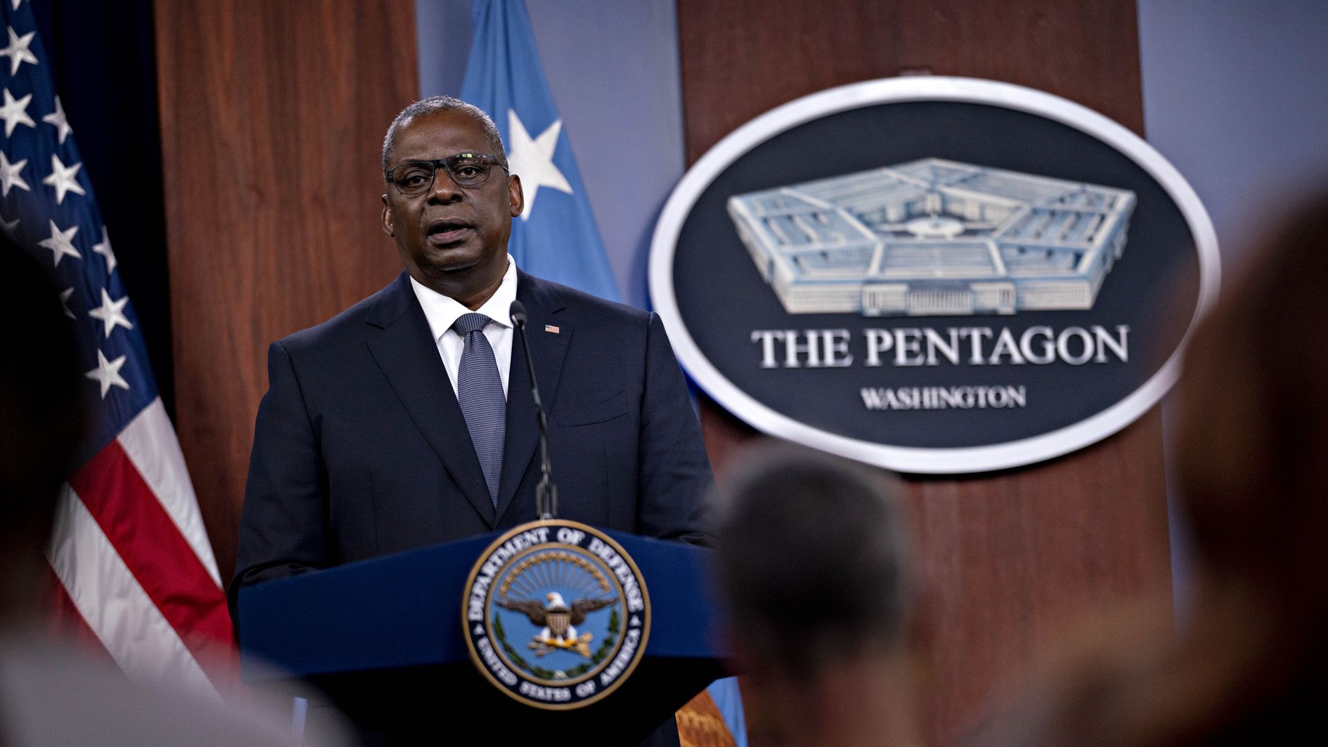 Photo of Lloyd Austin speaking from a podium with the Pentagon sign behind him