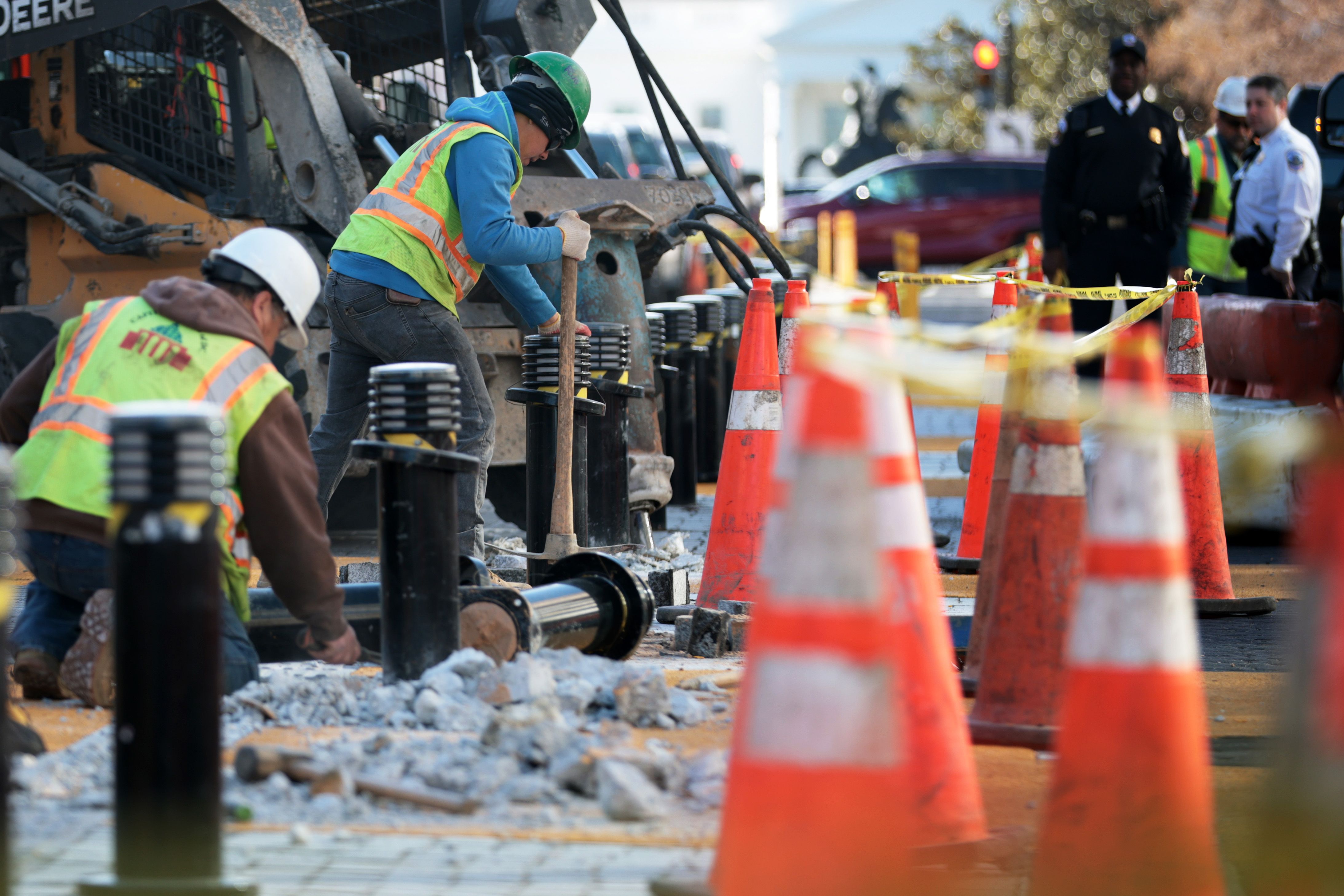 Crews work on removing bollards as part of construction work