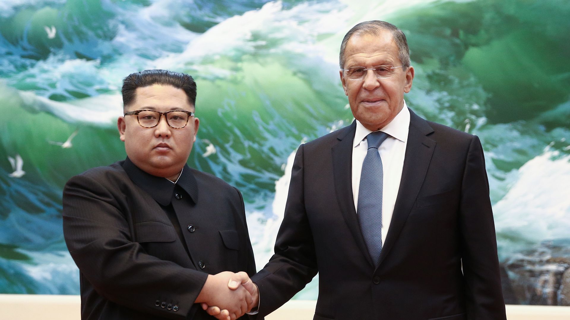 Kim Jong Un and Sergei Lavrov shaking hands