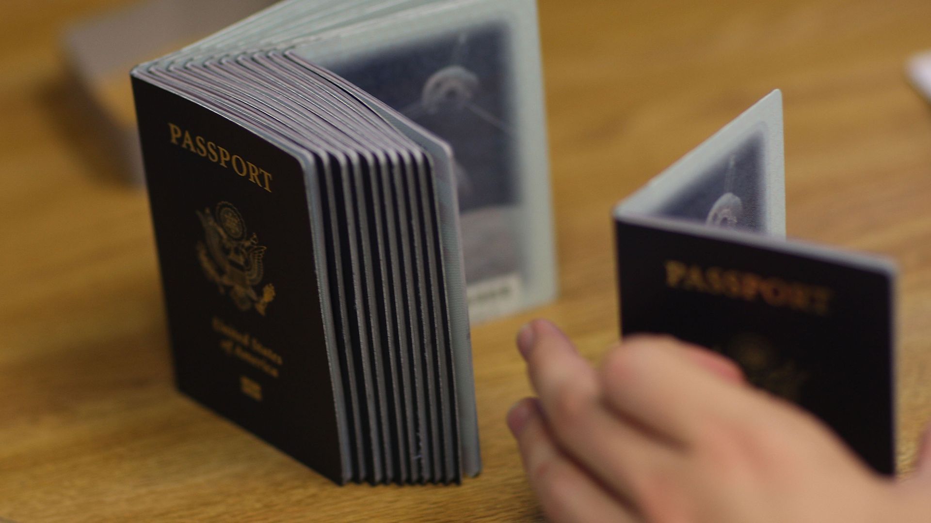A photograph of a vertical stack of U.S. Passports