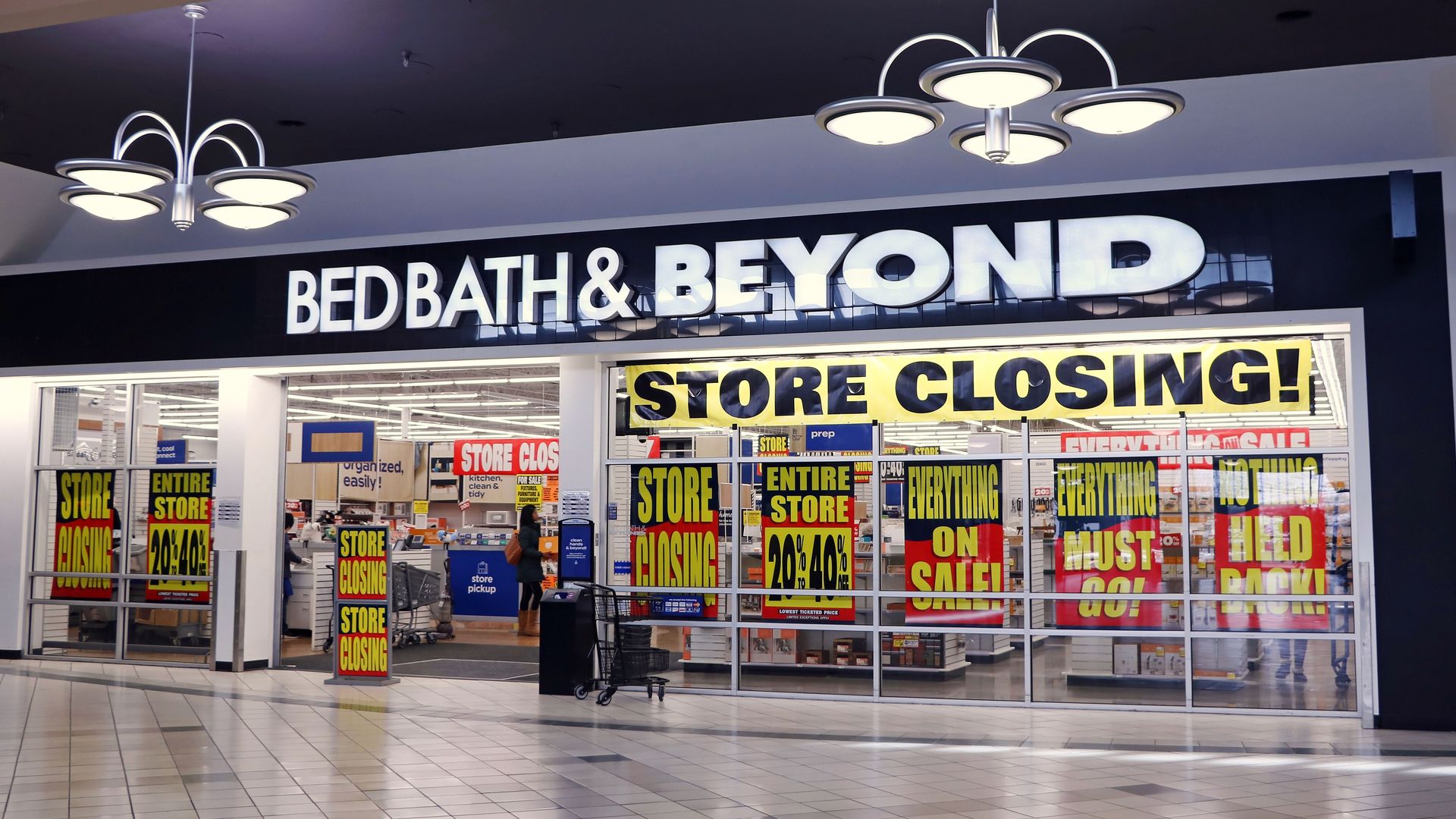 A store closing sign hanging over a Bed Bath & Beyond store front.
