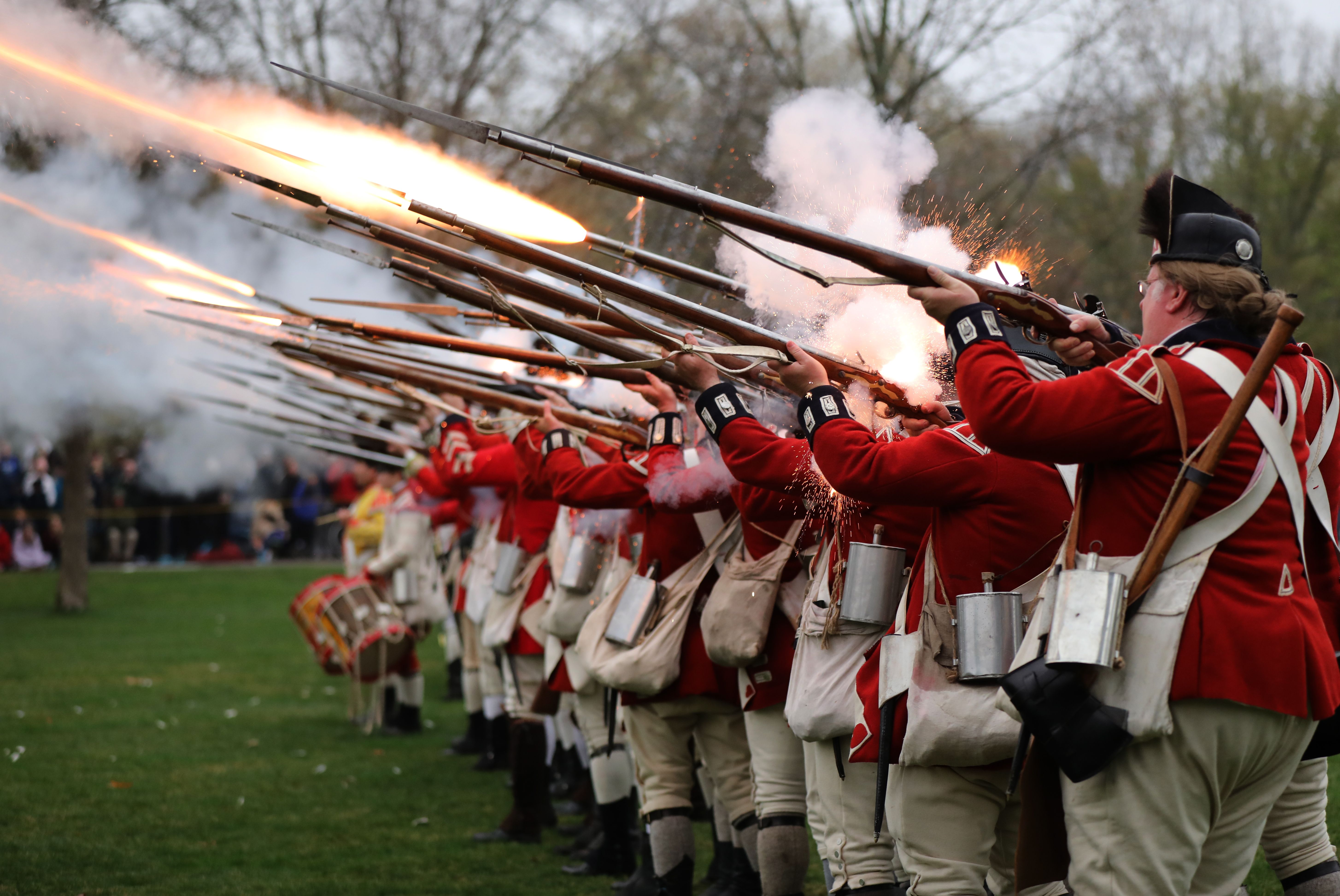 People fire muskets in a reenactment