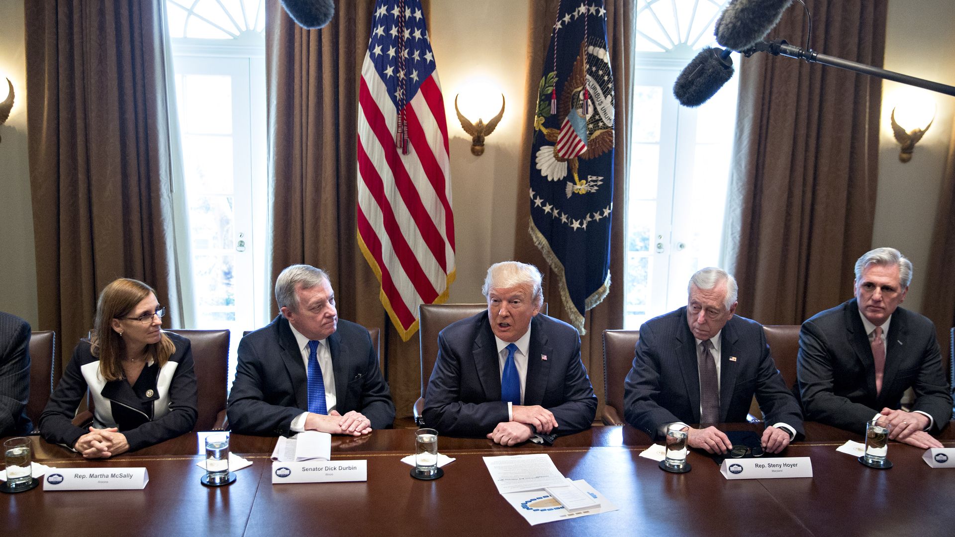 Trump sits with Sens. Dick Durbin and Jeff Flake.