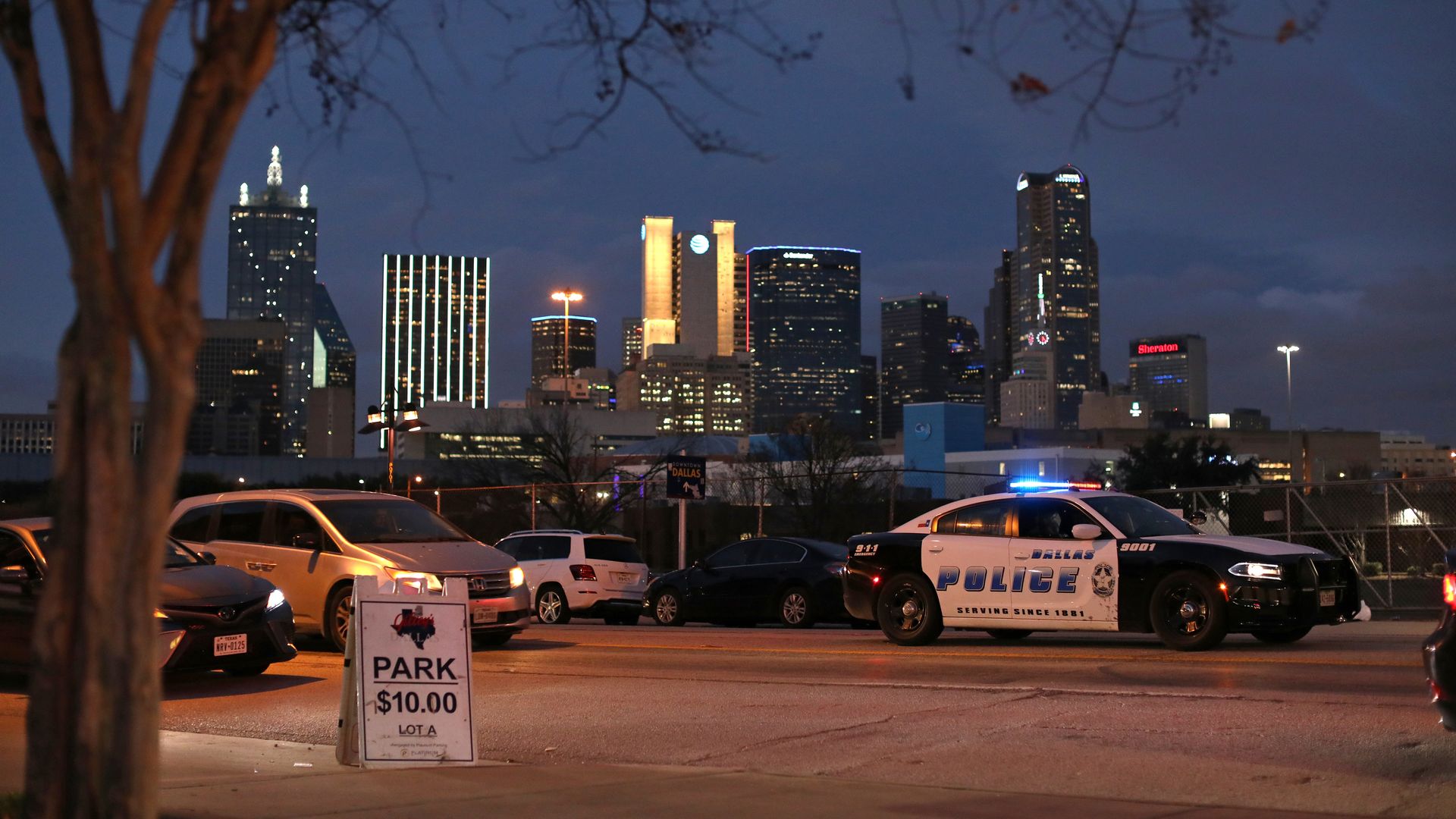 A photo of a Dallas police car in front of the city skyline 