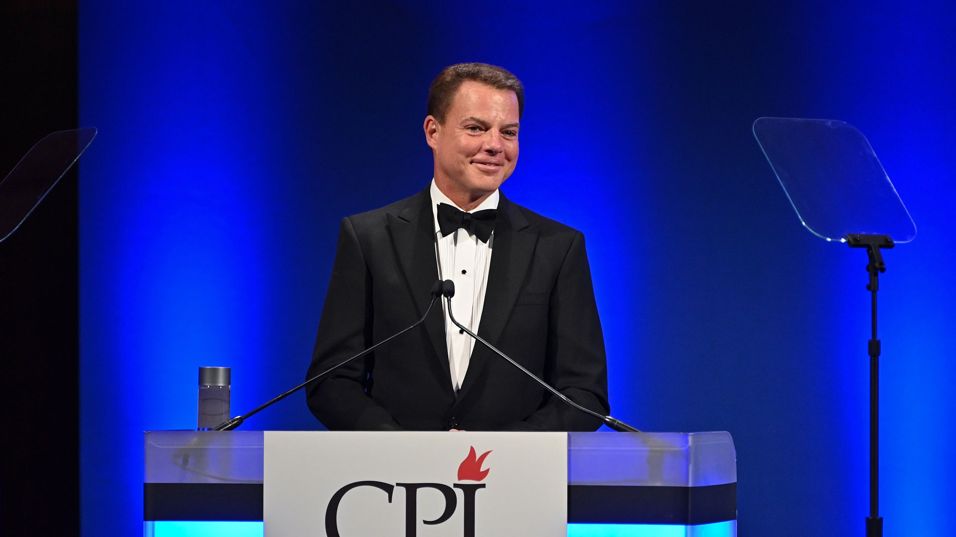 Photo of Shepard Smith smiling as he stands on stage behind a podium with the "CPJ" logo