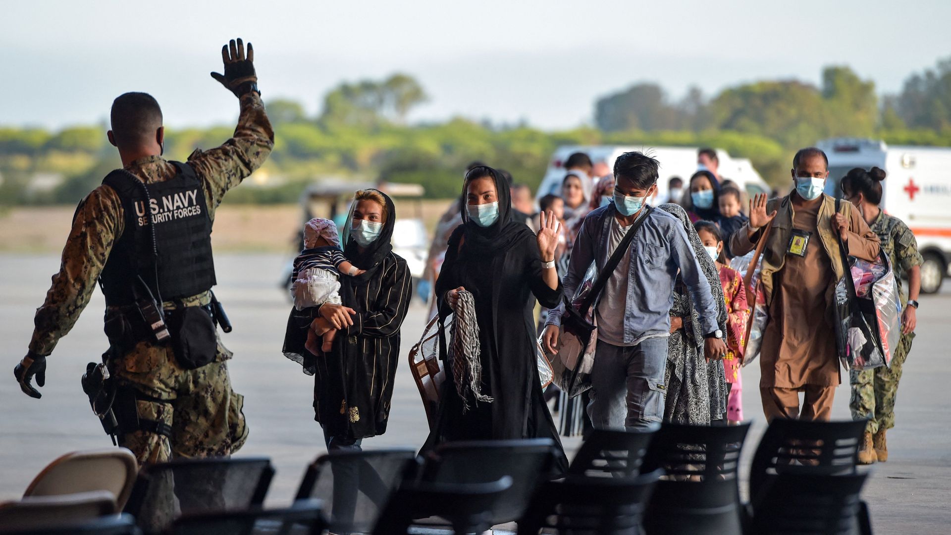 Afghan refugees and U.S. service member