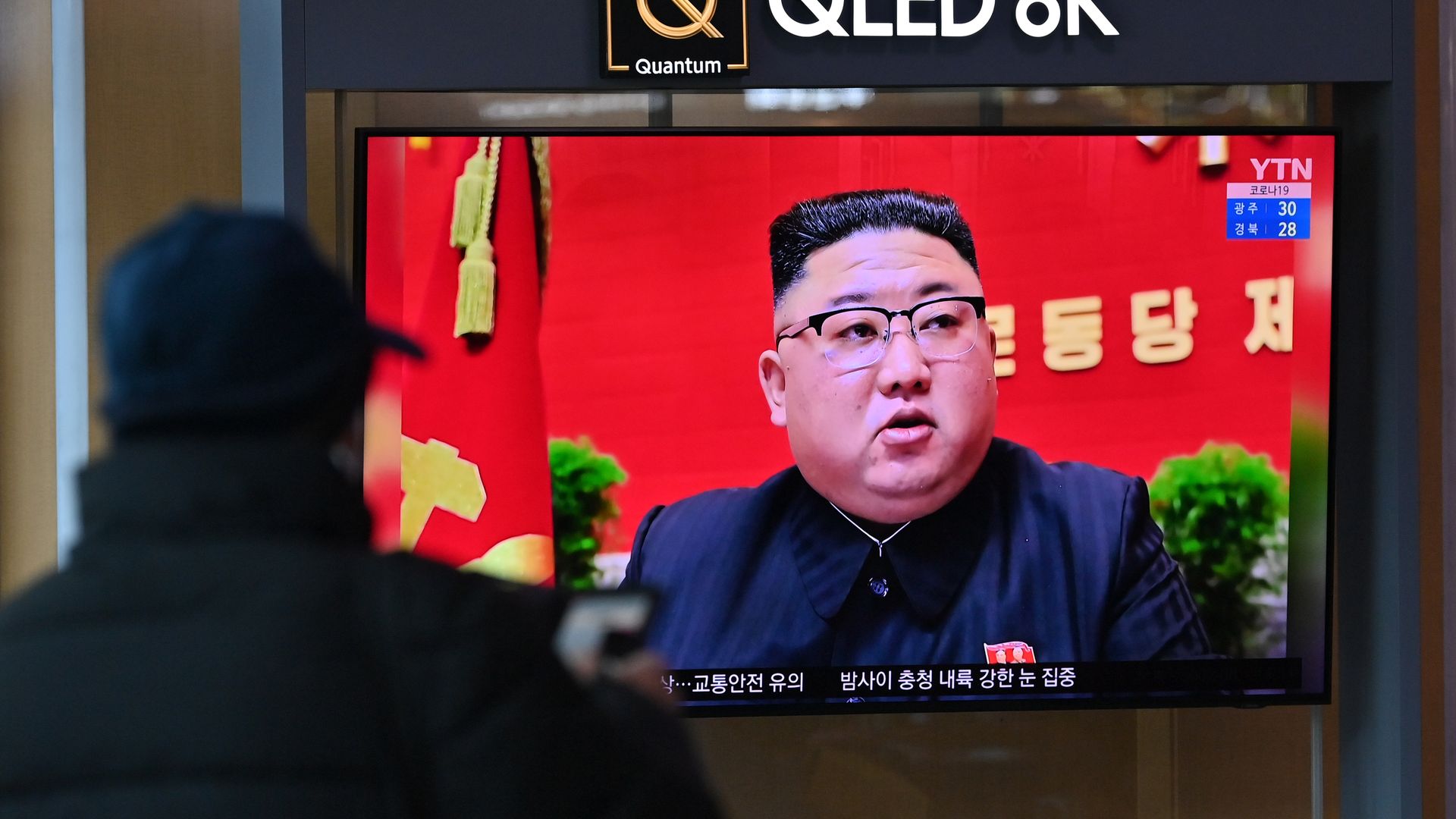 A person watching Kim Jong-un on a television in Seoul, South Korea, in January 2021.
