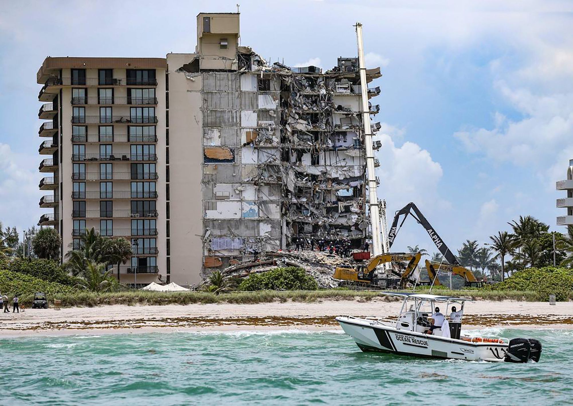 A Miami-Dade judge decided Friday to donate up to $3 million in extra settlement funds to the families of the 98 people who were killed in the collapse of the Champlain Towers South condo in Surfside, shown here before it was razed. (Al Diaz/Miami Herald/Tribune News Service via Getty Images)
