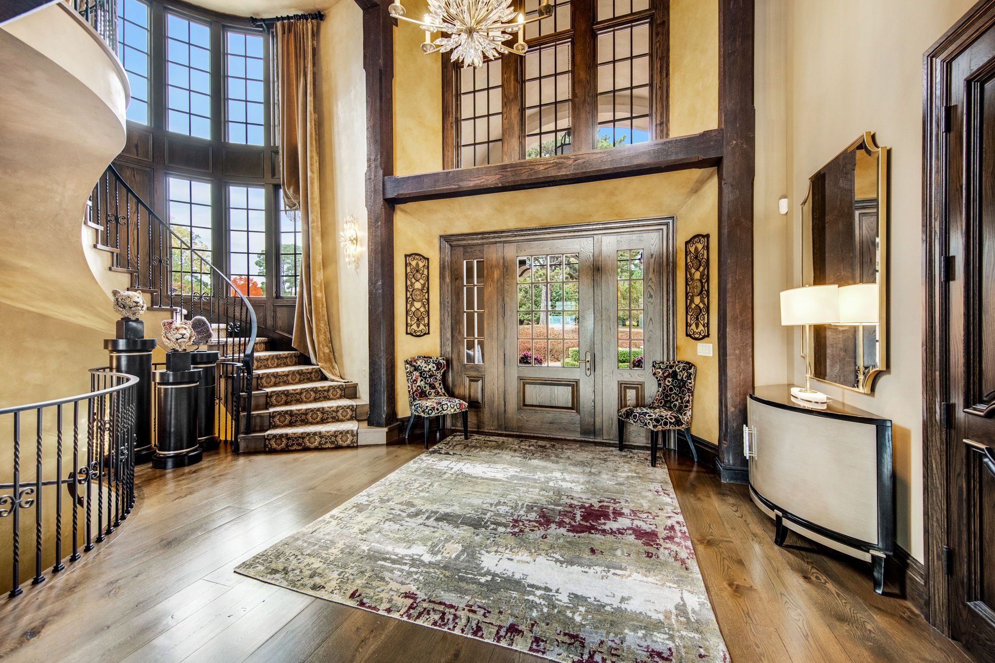 A foyer with yellow walls and dark wood accents.