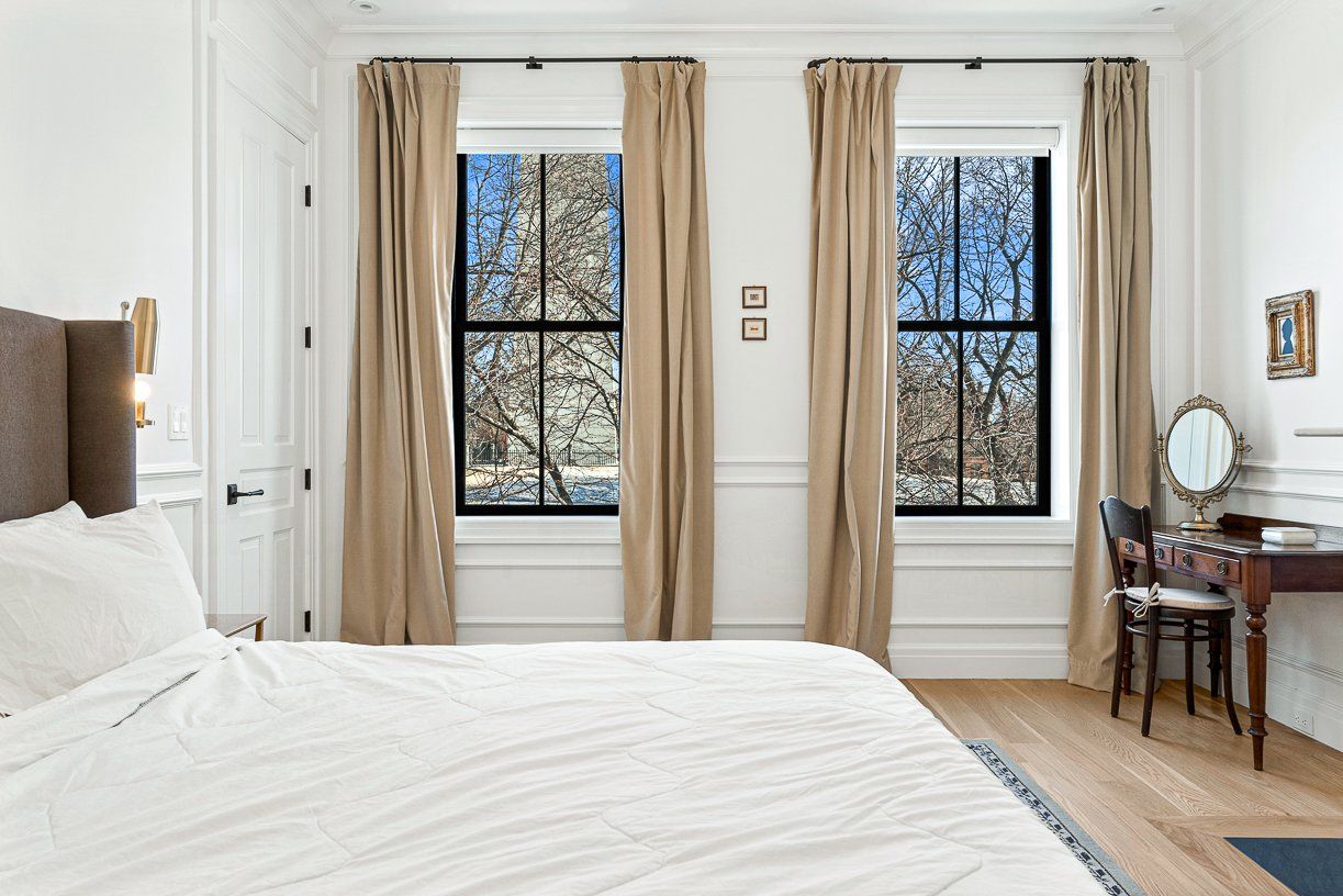 A real estate photo showing a bedroom in 31 Monument Square in Charlestown, next to the Bunker Hill monument.