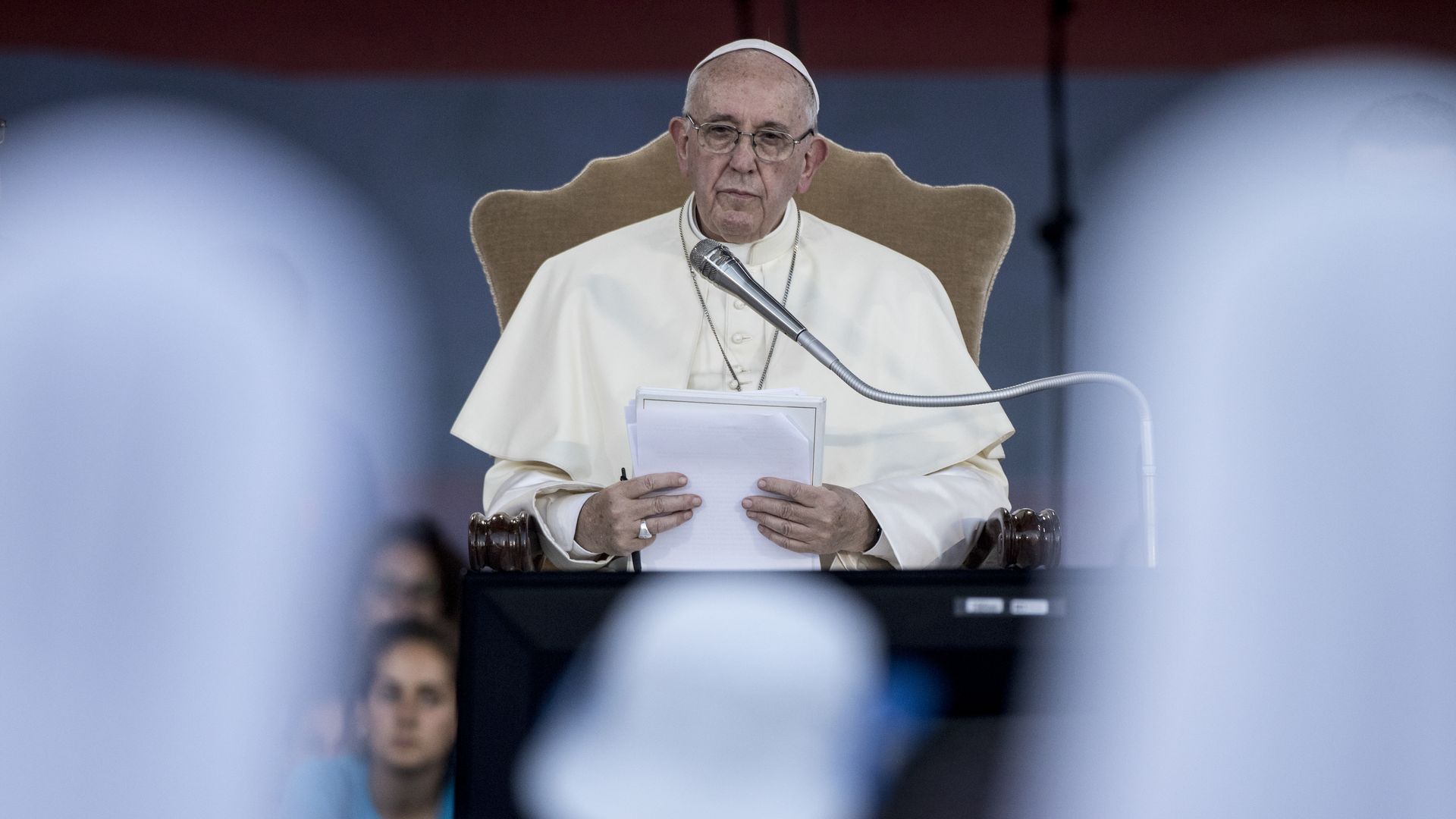 Pope Francis sitting at a mic but not talking