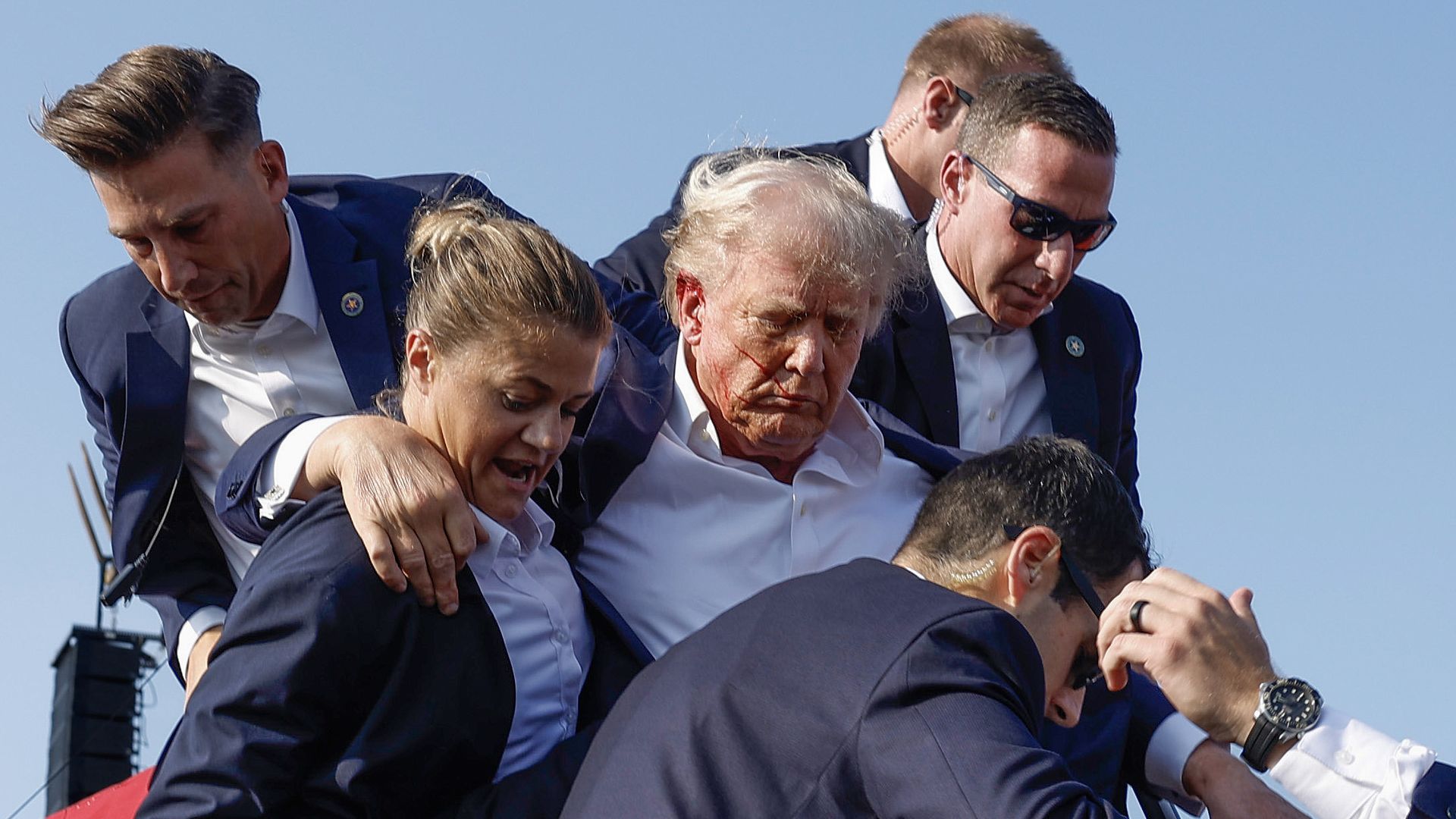 President Trump being grabbed by multiple Secret Service officers.