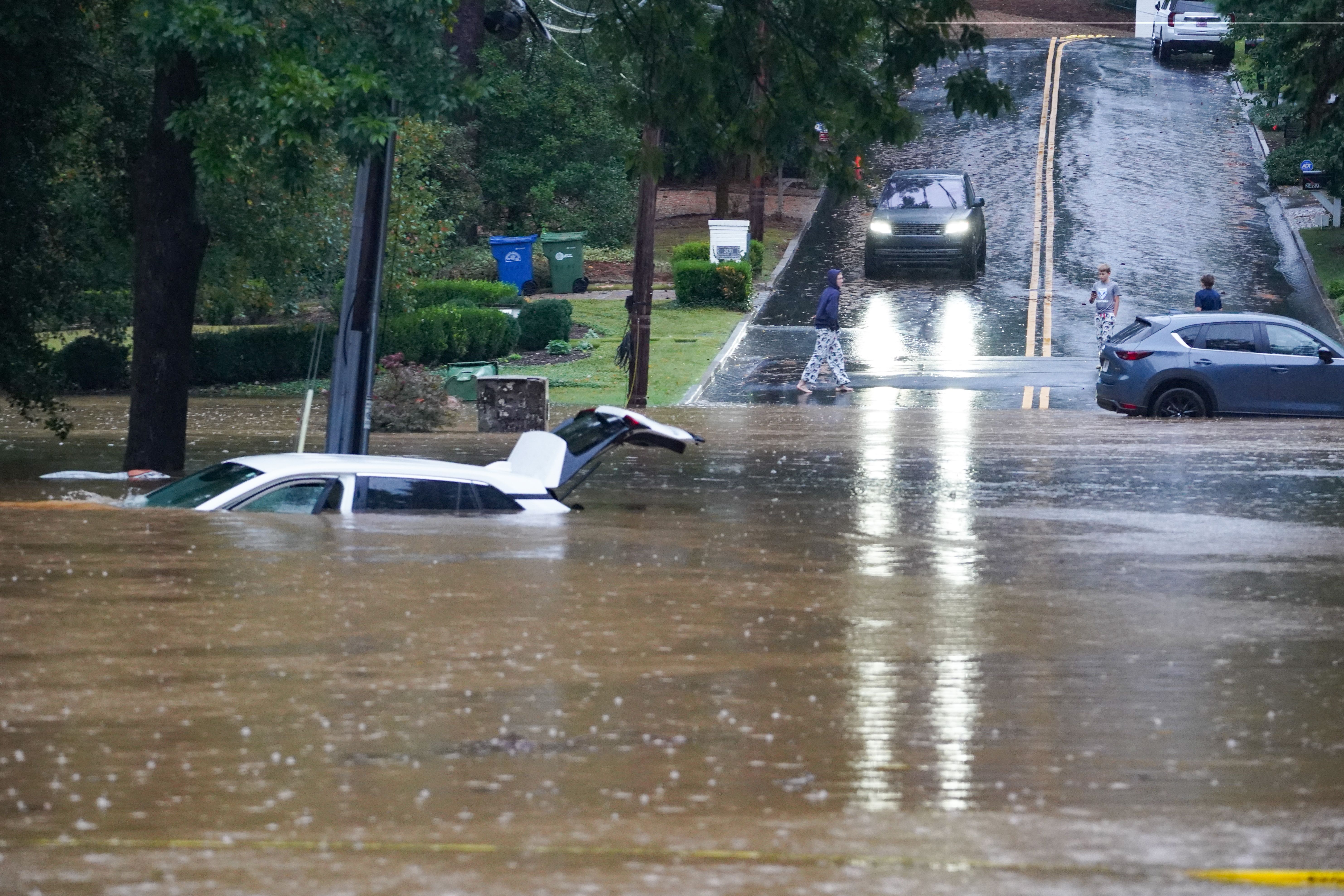 A car submerged in water with its hatchback open in Atlanta after Hurricane Helene