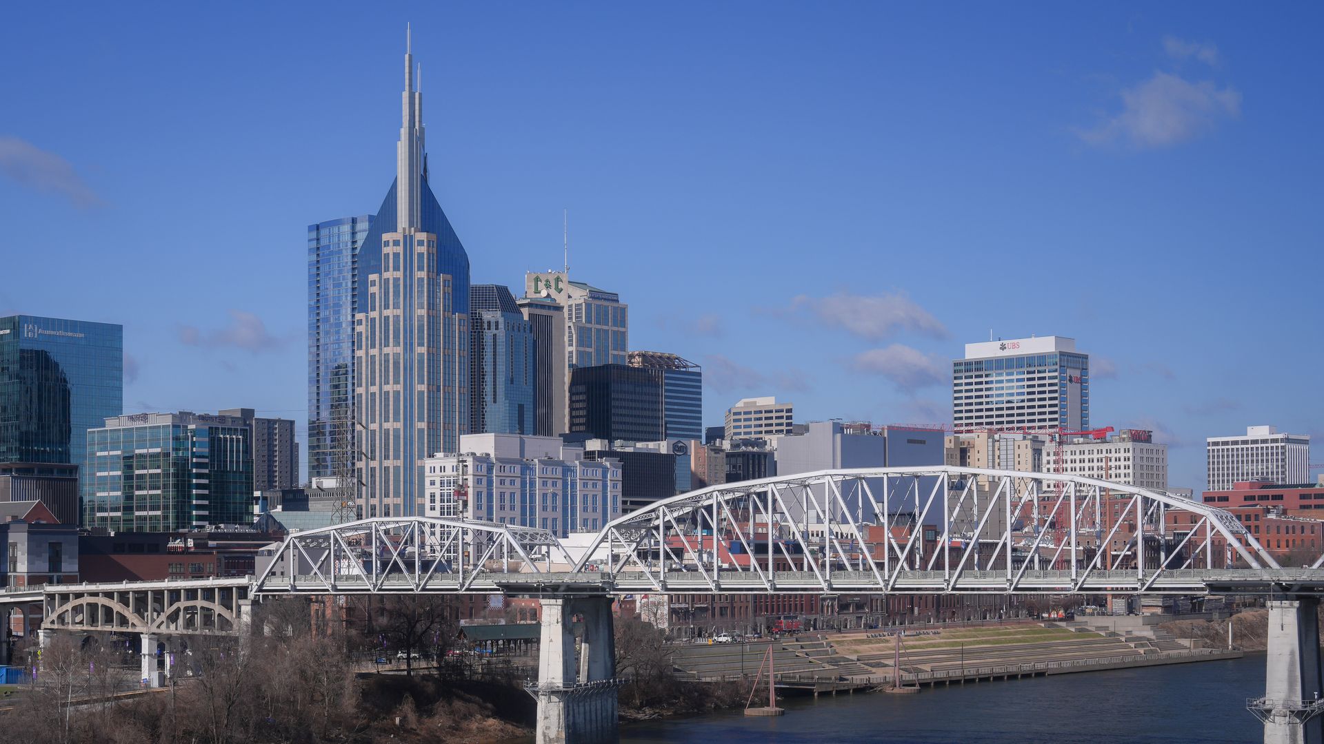 The downtown Nashville skyline towers above Cumberland River