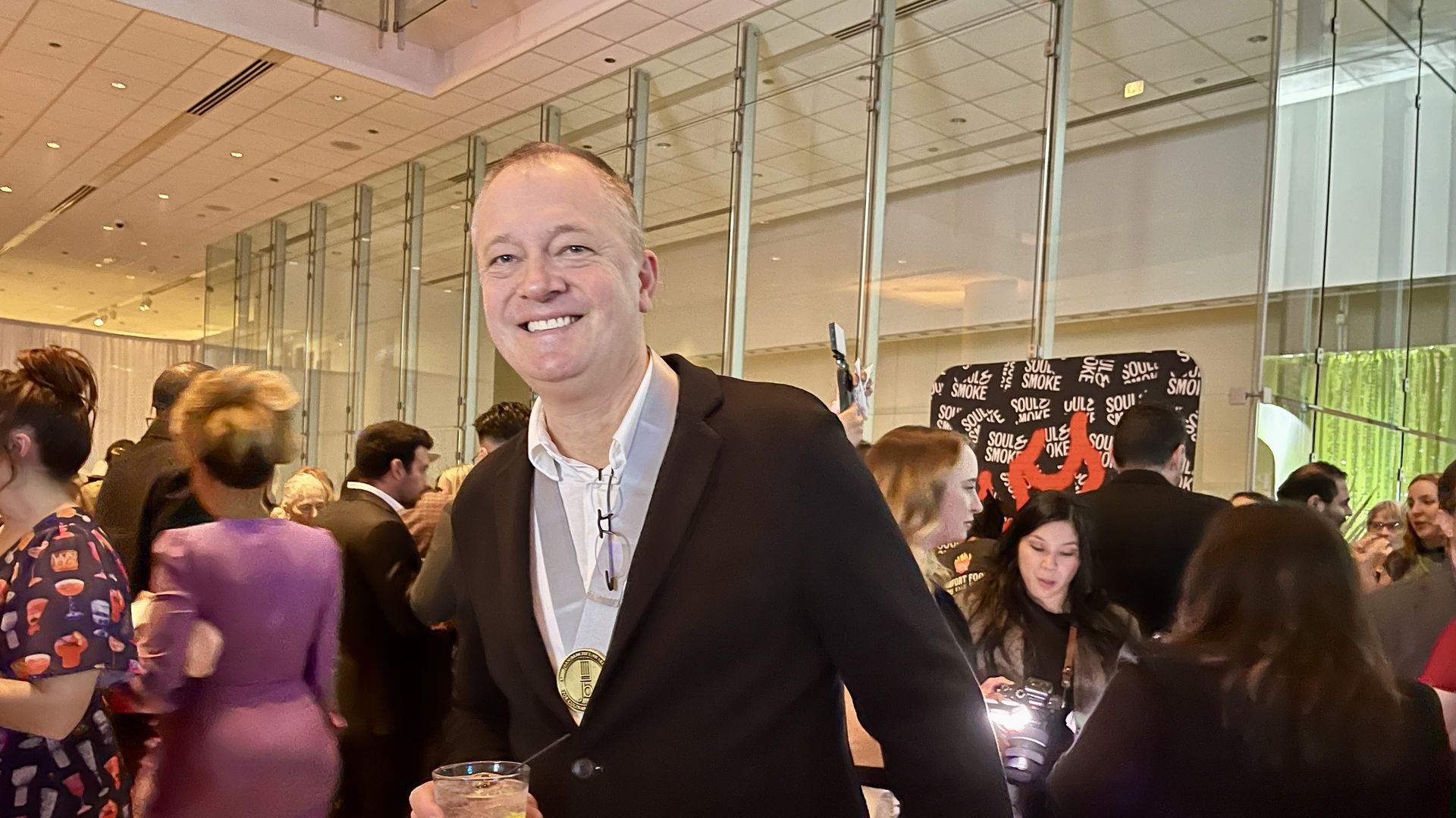 Man with a drink in his hand.