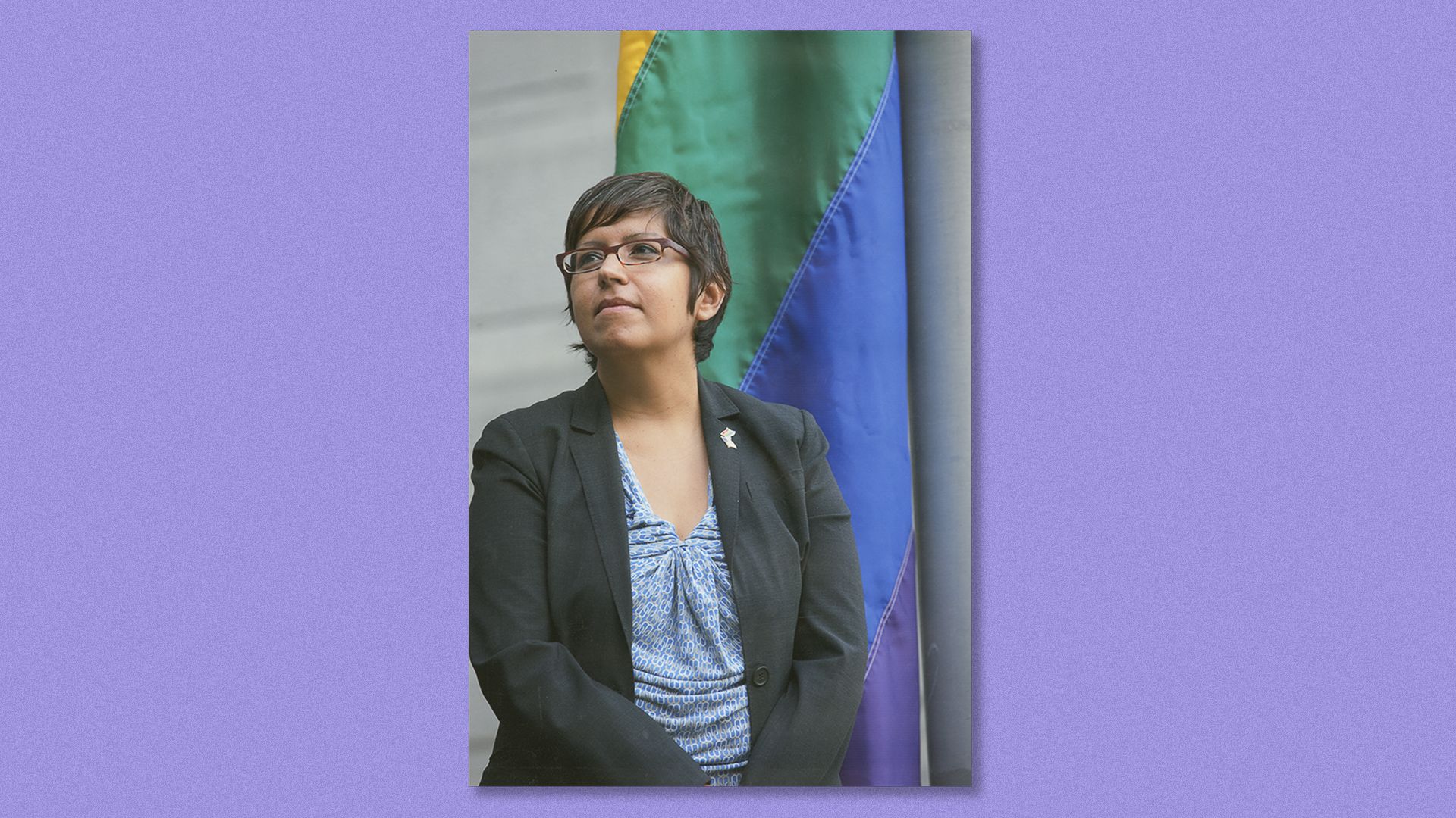 Gloria Casarez in front of the rainbow flag at City Hall the first year it was flown for LGBT History Month.