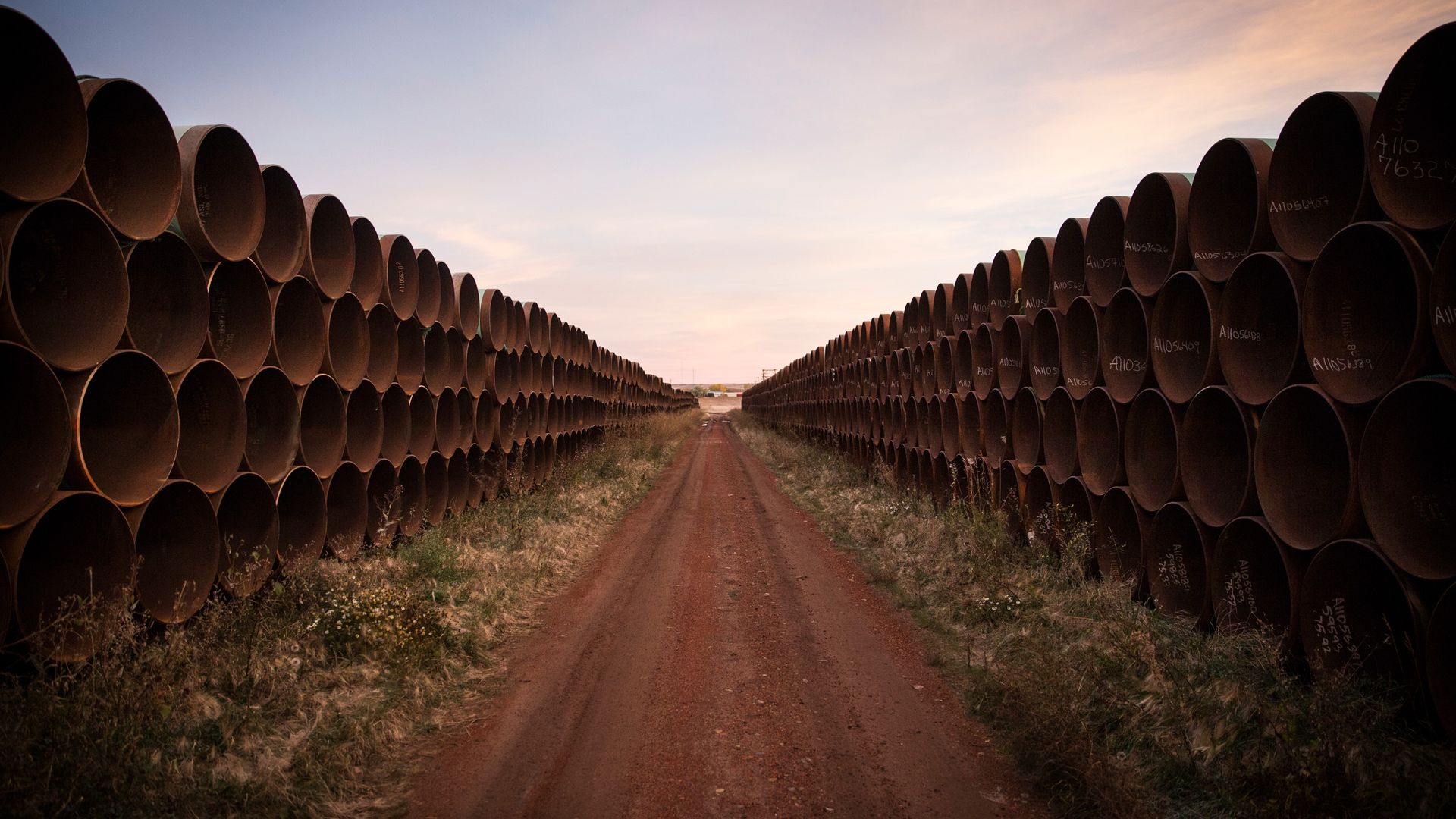 Miles of unused pipe, prepared for the proposed Keystone XL pipeline, sit in a lot on October 14, 2014 outside Gascoyne, North Dakota.