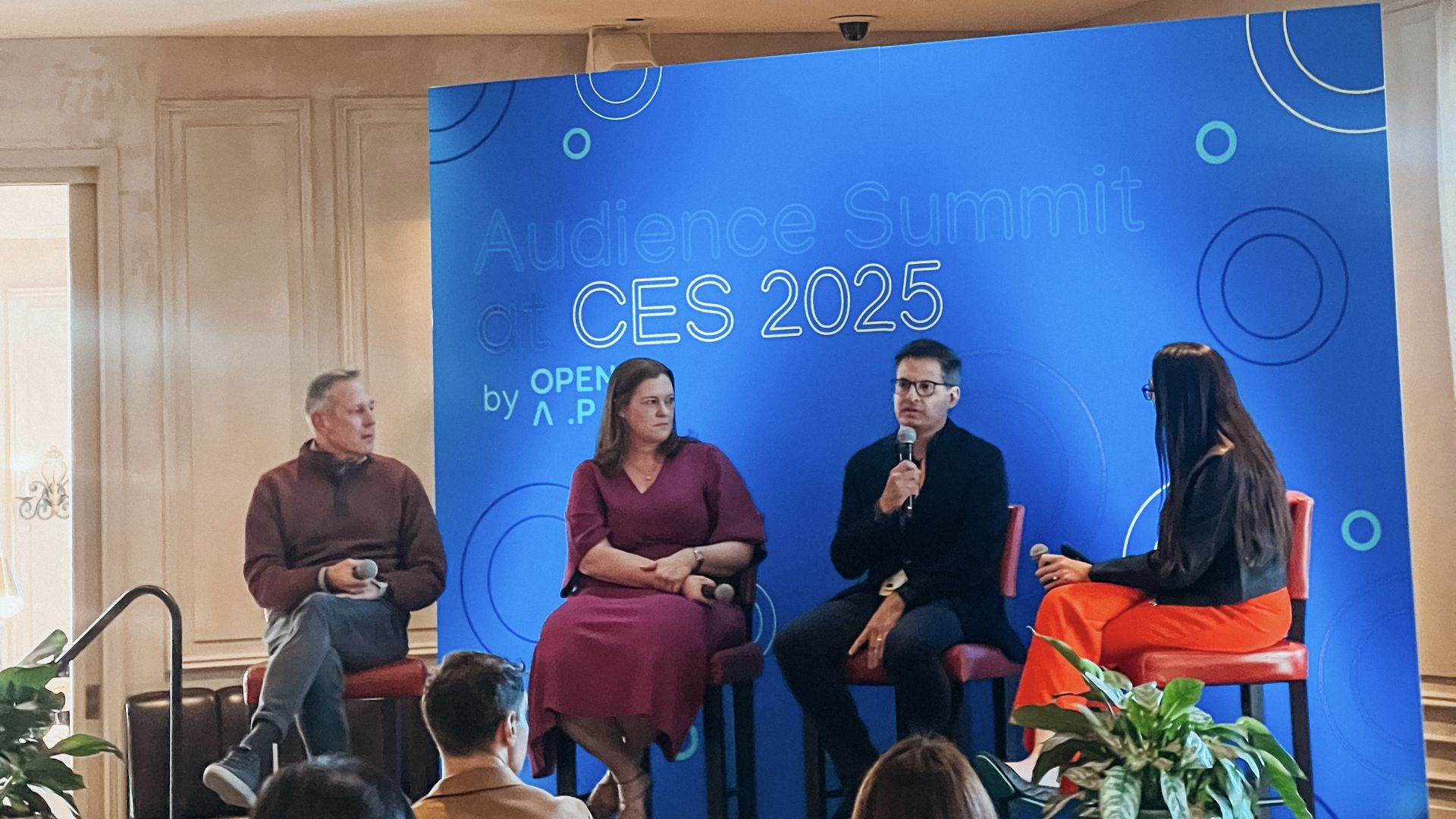 David Porter, Lexi Swift, Mike Piner, Kerry Flynn sitting on a stage with Audience Summit CES 2025 by OpenAP on a wall behind them.