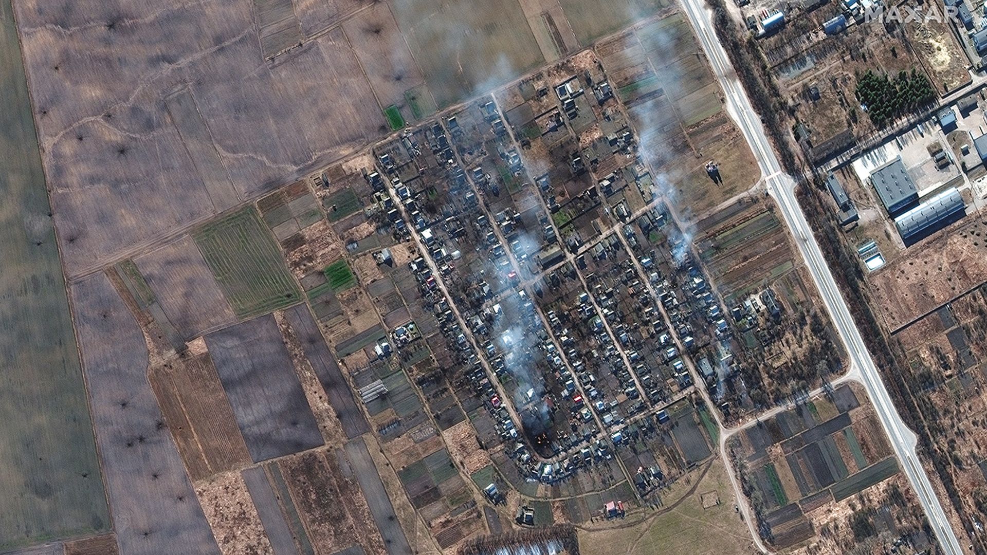 Satellite imagery of burning homes and impact craters in rural Ukraine. Photo: Maxar Technologies
