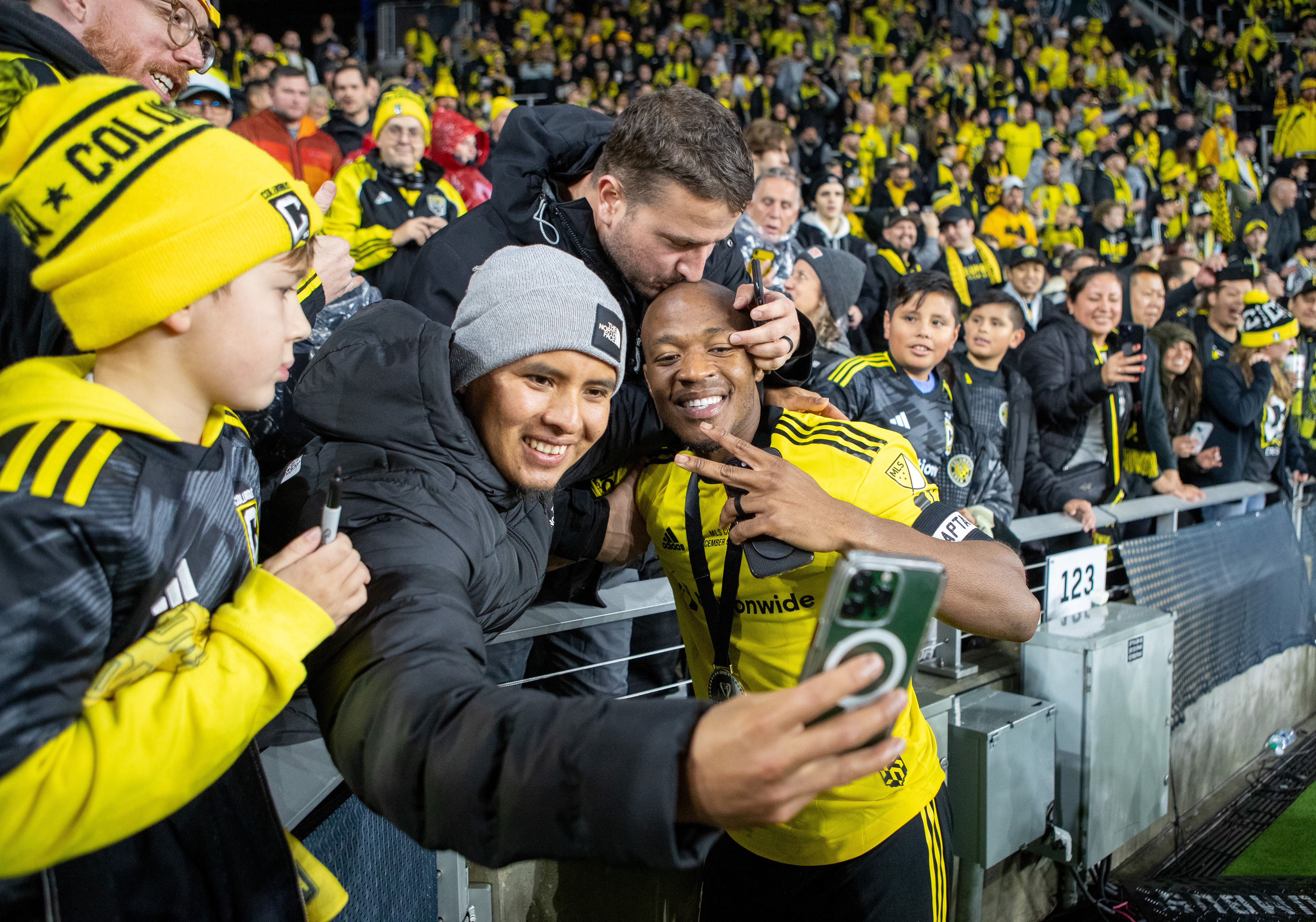 Darlington Nagbe poses with fans after the Columbus Crew's 2023 MLS Cup win