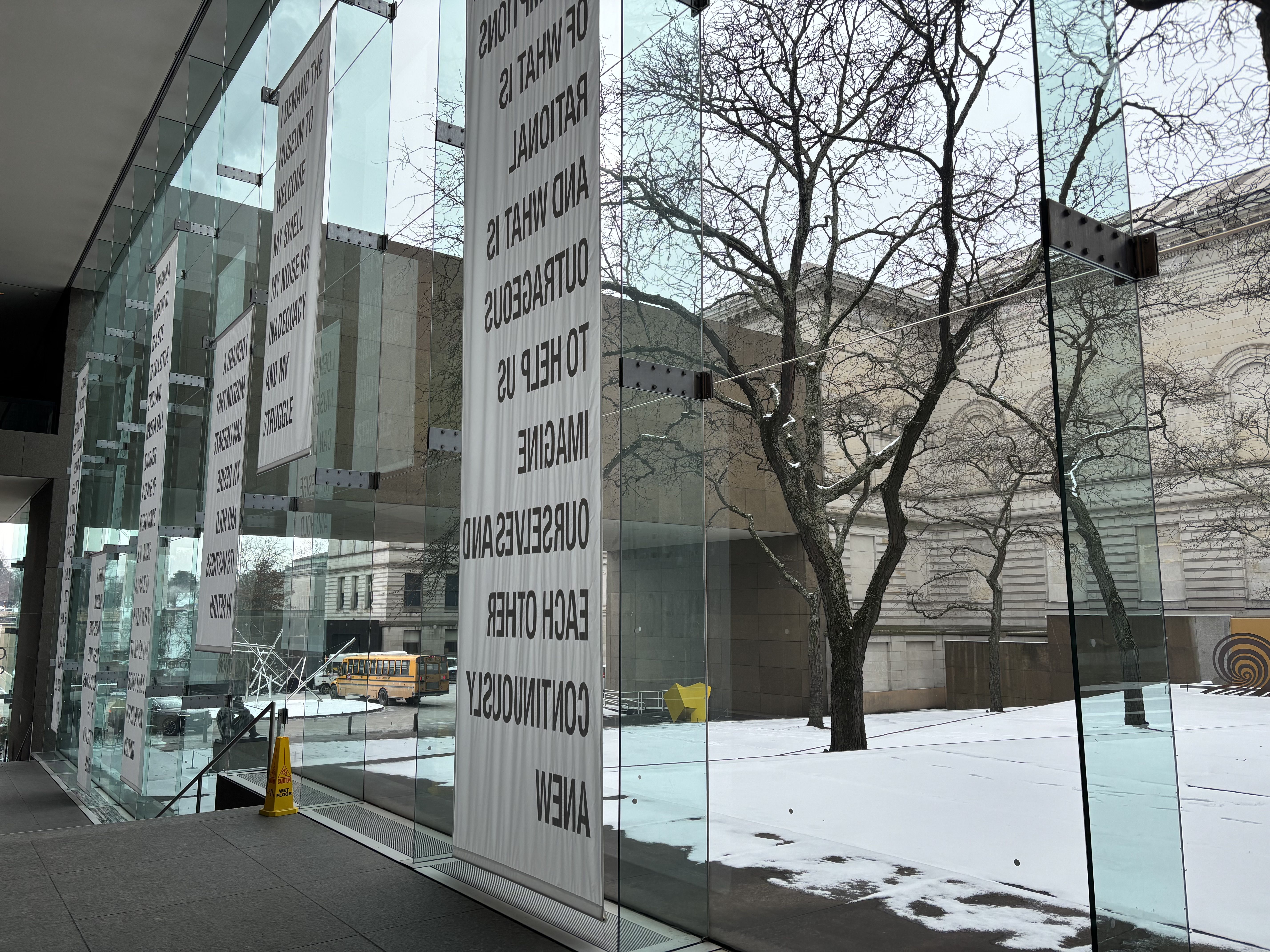 Inside Carnegie Museum's atrium showing a snowy courtyard