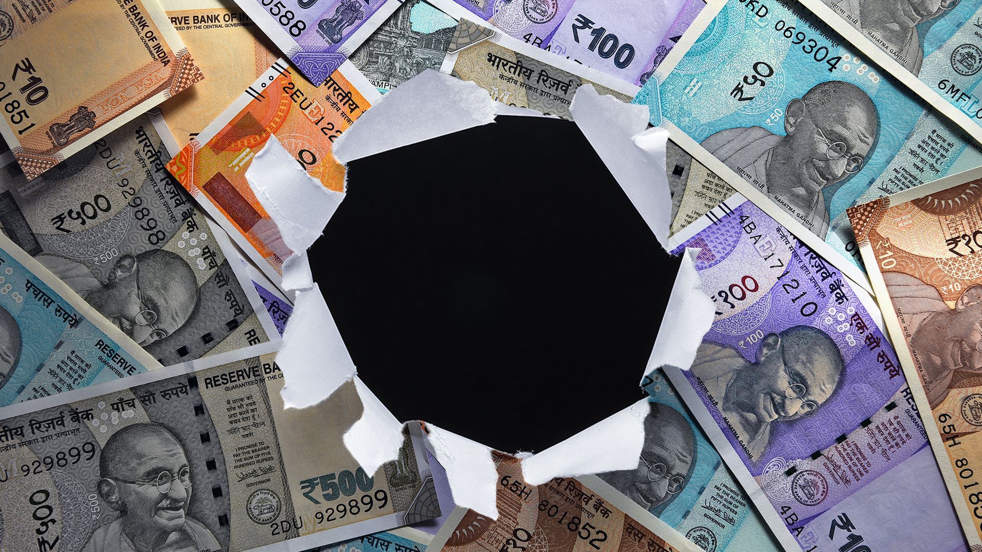 Illustration of a pile of Indian rupees with a hole torn in the center