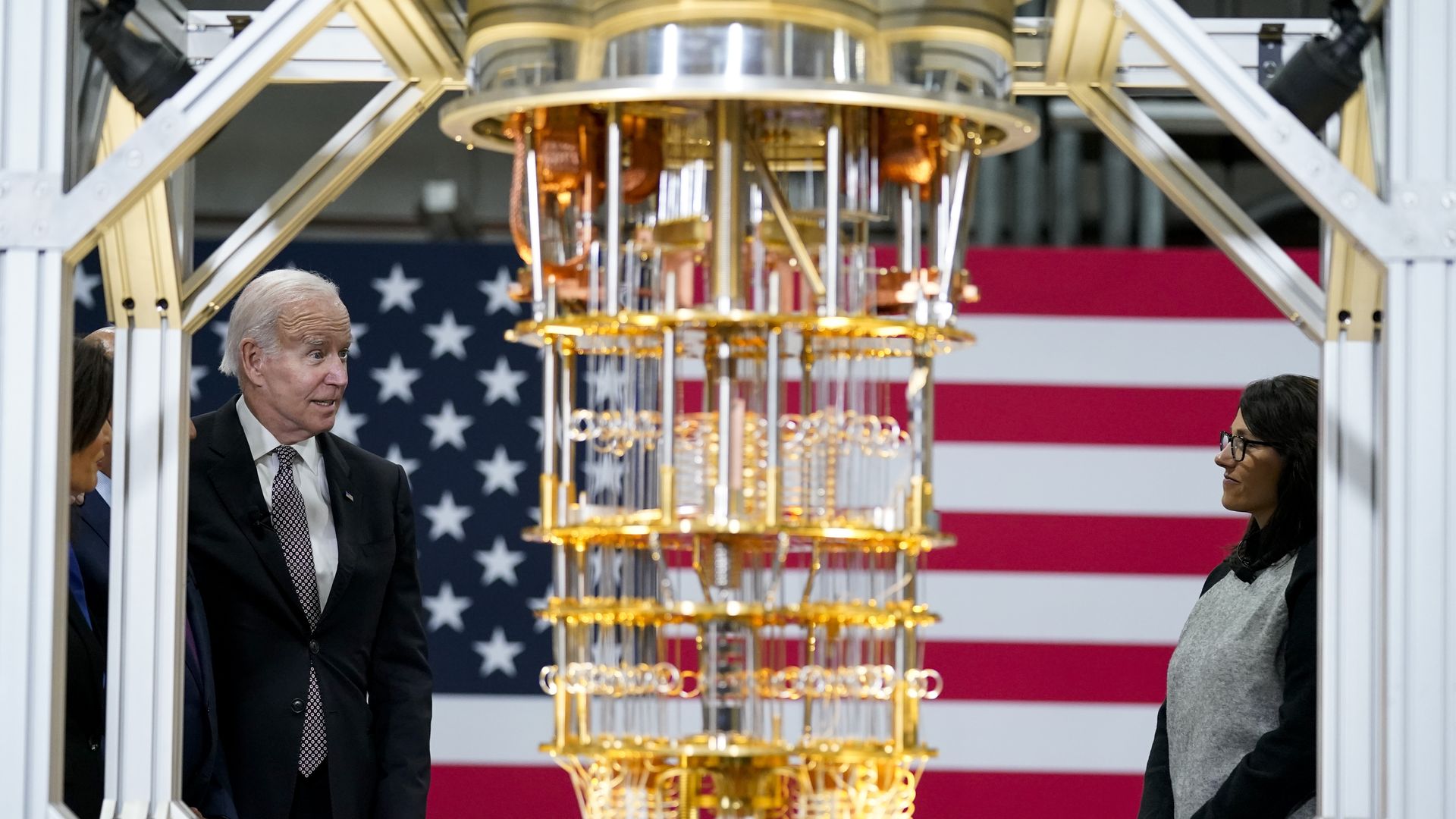 President Biden standing beside an IBM System One quantum computer 
