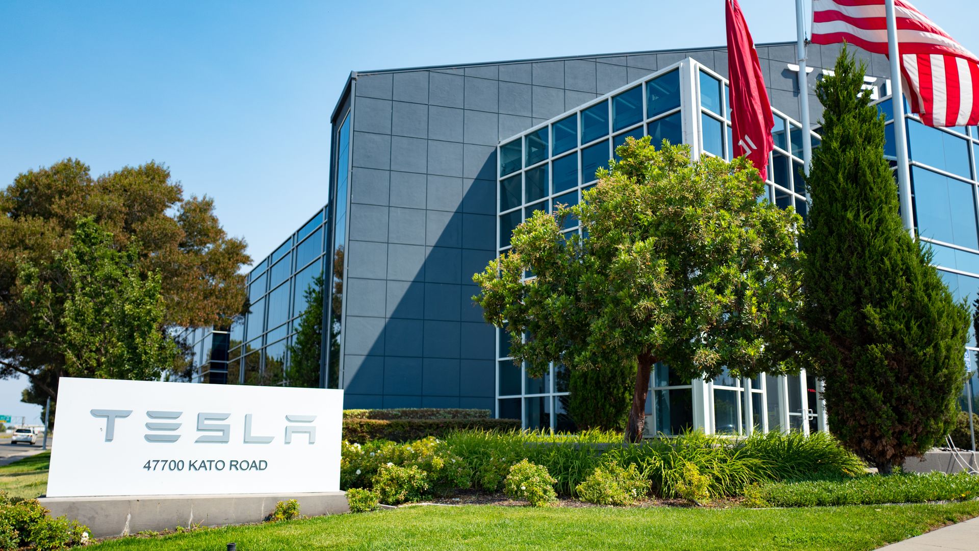 Tesla Motors in front of new glass building near the company's headquarters